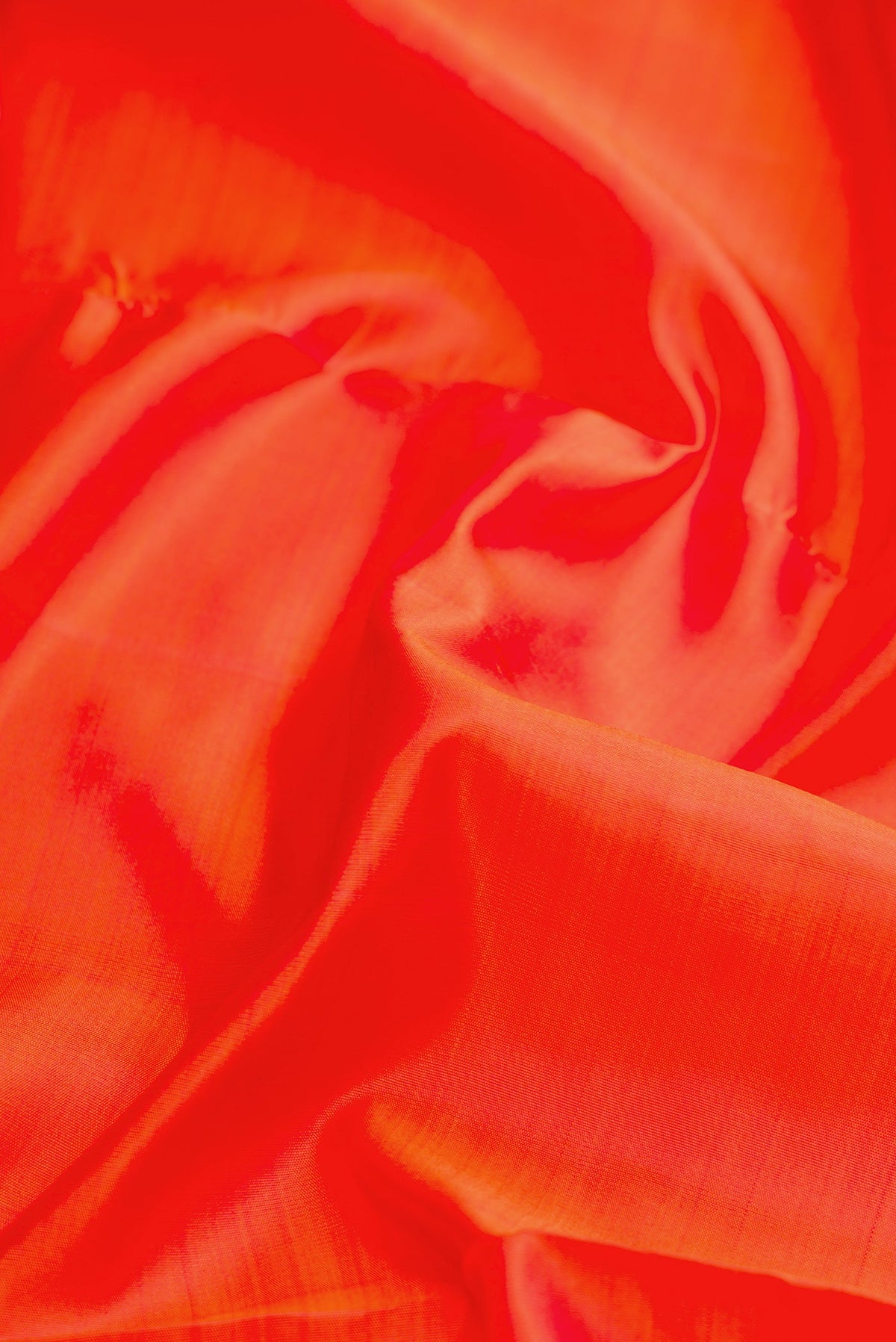 Close up of Pure Silk Pure Zari Orange Dual Tone Kanjivaram Nine Yards Saree with Plain Body and Zari Border.  displaying folds