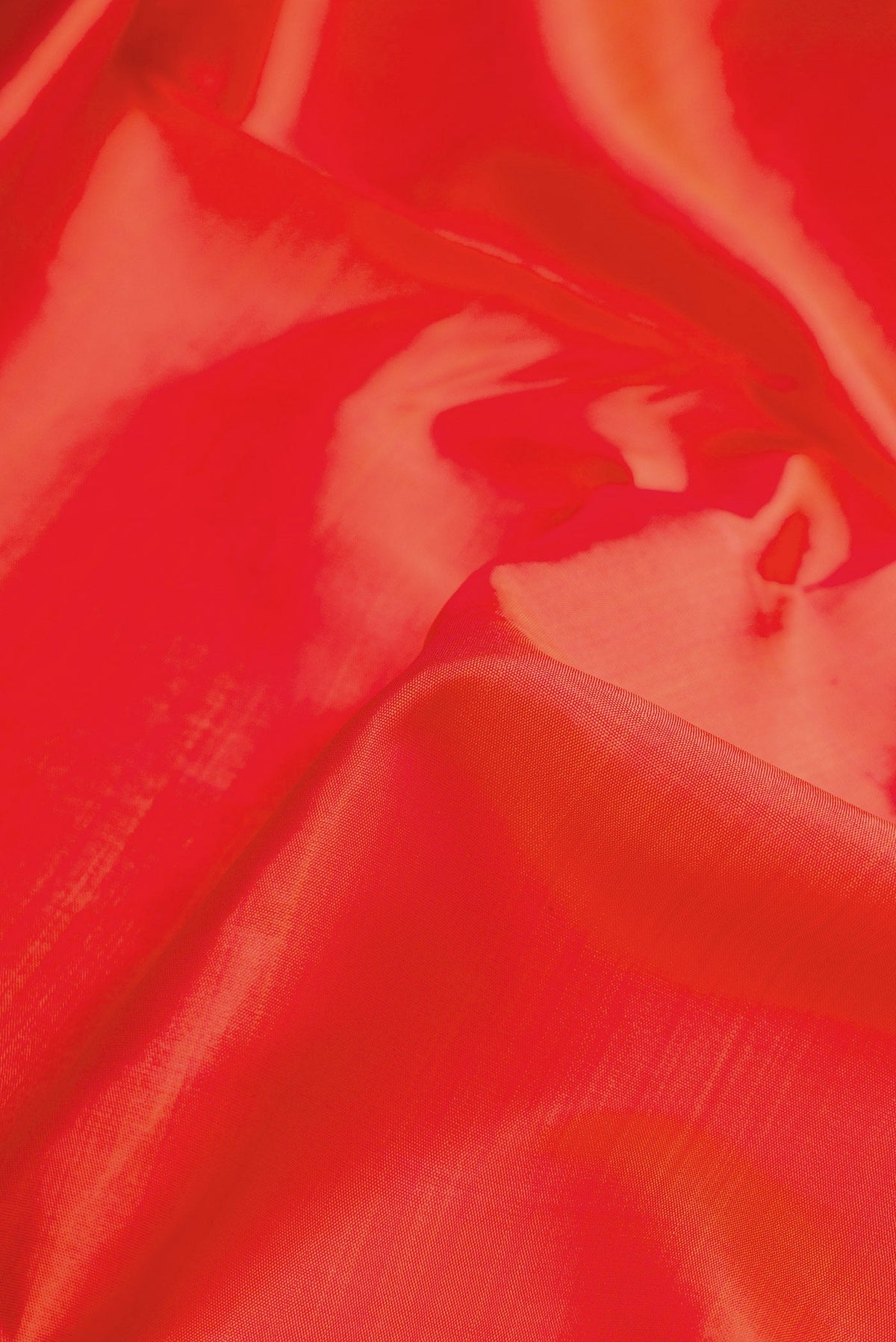 Close up of Pure Silk Pure Zari Orange Dual Tone Kanjivaram Nine Yards Saree with Plain Body and Zari Border.  displaying folds