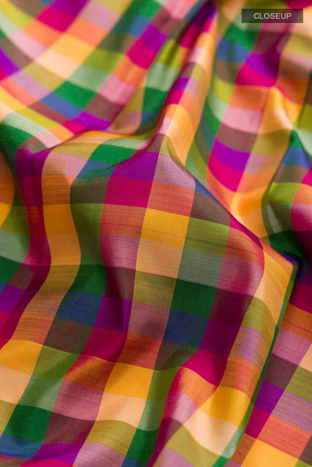 Close up of Multi Color Kanchipuram Silk Saree with Checked design on the body and Without Border displaying folds