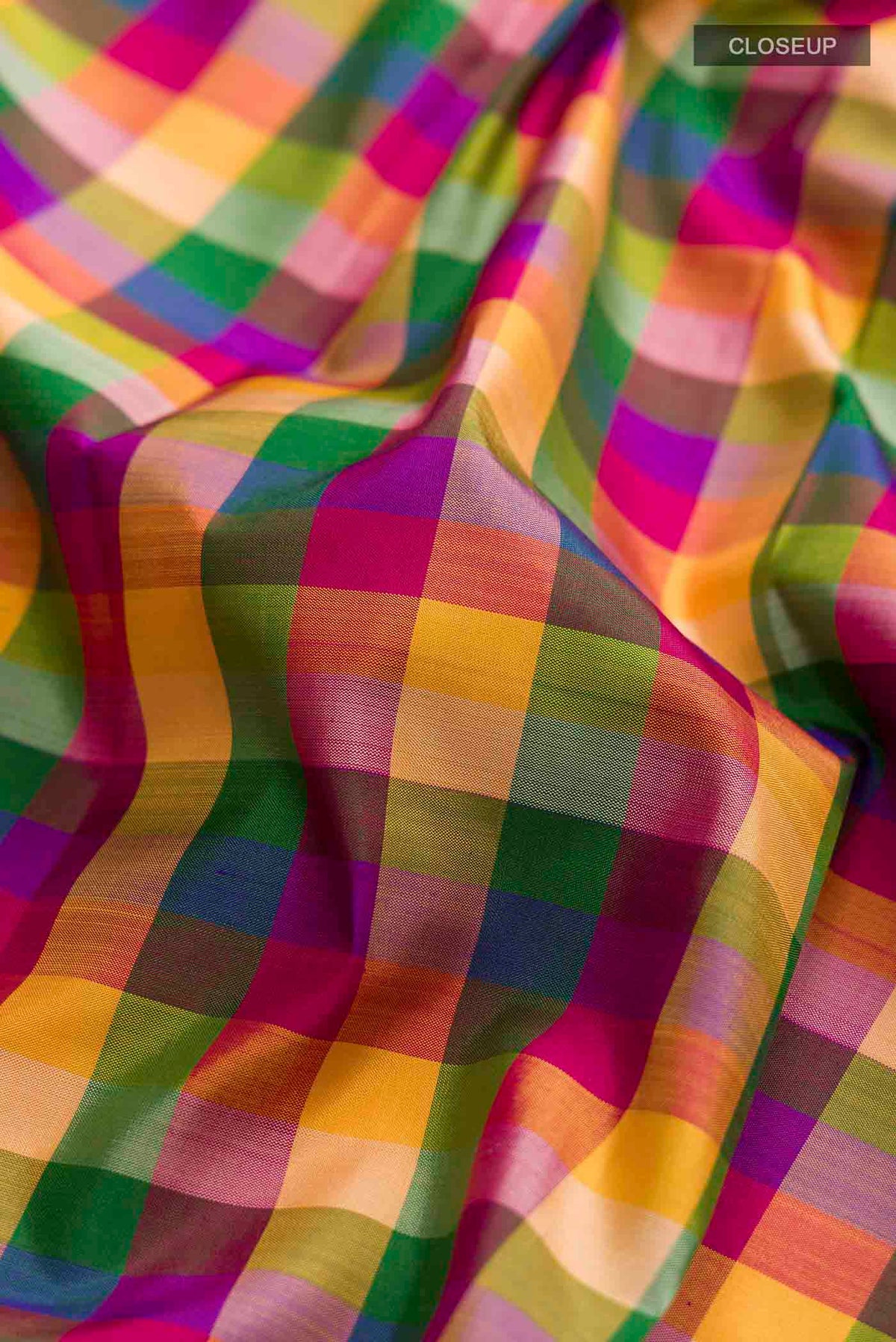 Close up of Multi Color Kanchipuram Silk Saree with Checked design on the body and Without Border displaying folds