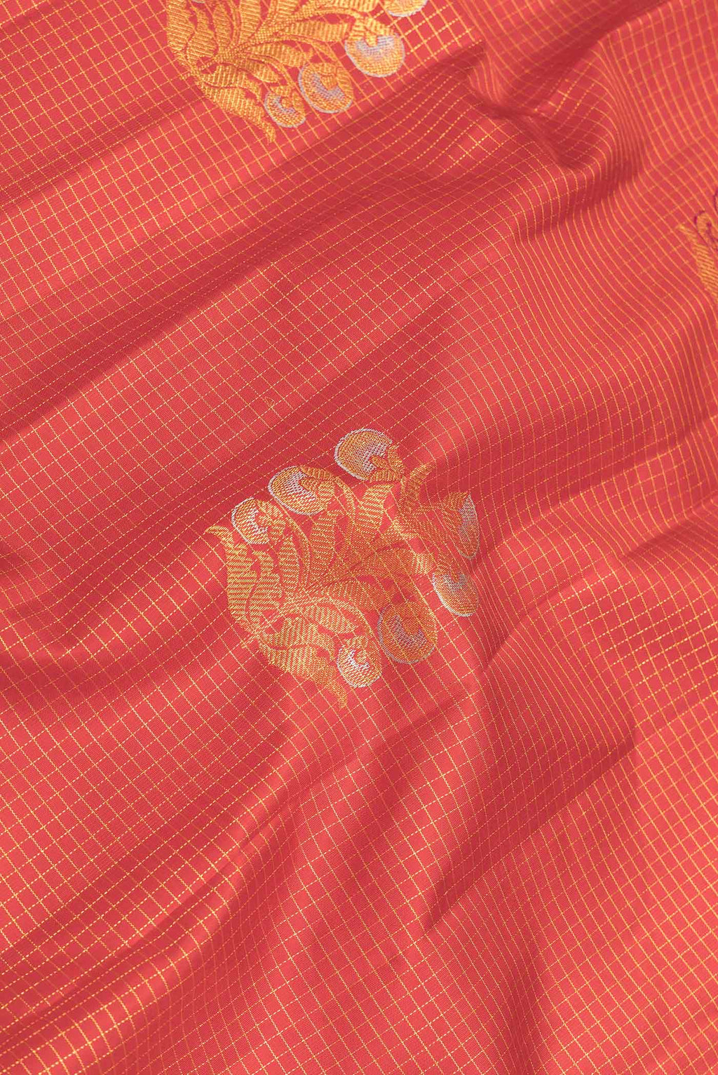Close up of Red Dual Tone Kanchipuram Saree with Checked design on the body and Without Border displaying folds