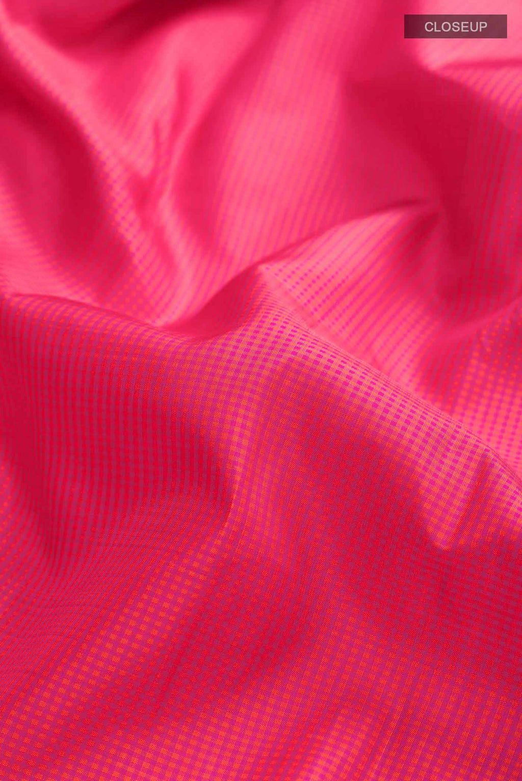 Close up of Pink Kanchipuram Silk Saree with Checked design on the body and Zari Border displaying folds