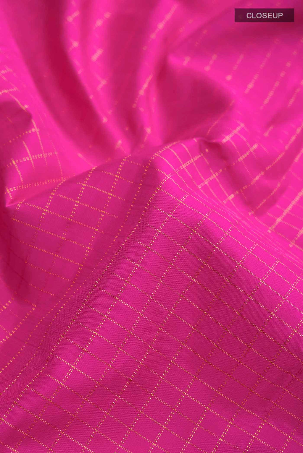 Close up of Pink Kanchipuram Silk Saree with Checked design on the body and Zari Border displaying folds