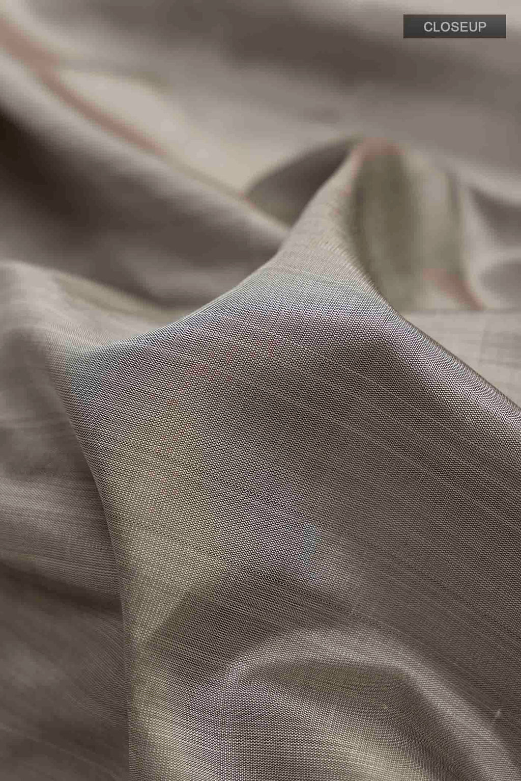 Close up of Grey Kanchipuram Silk Saree with Plain Body and Zari Border displaying folds