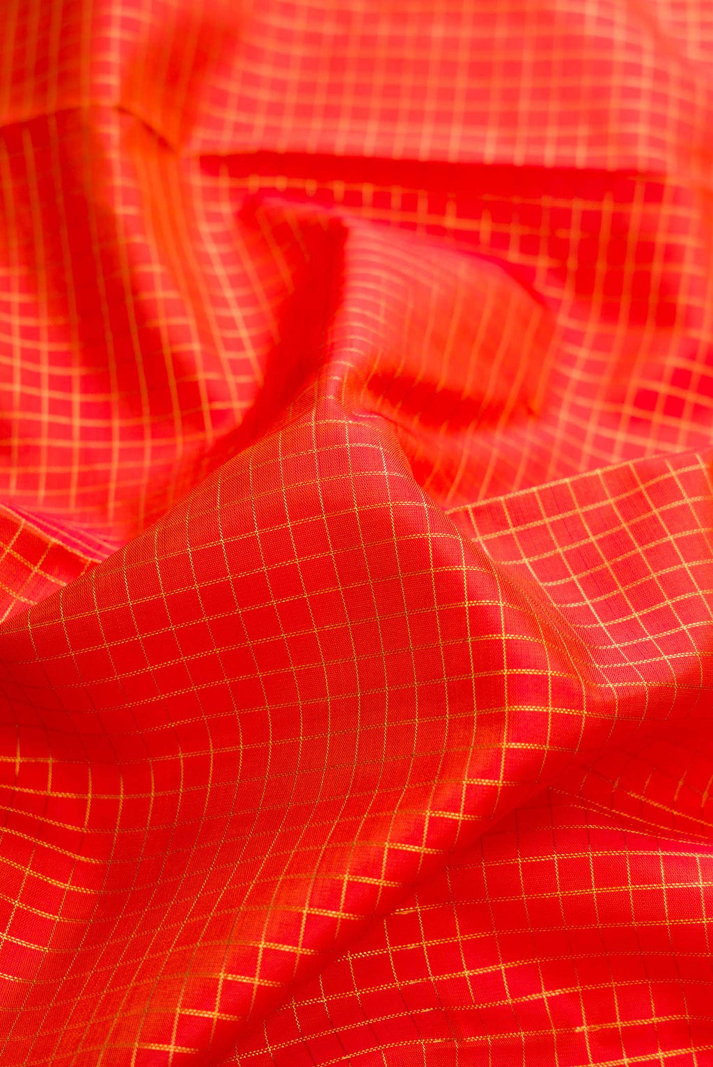 Close up of Pure Silk Pure Zari Orange Dual Tone Kanchipuram Saree with Stripes on the body and Zari Border displaying folds
