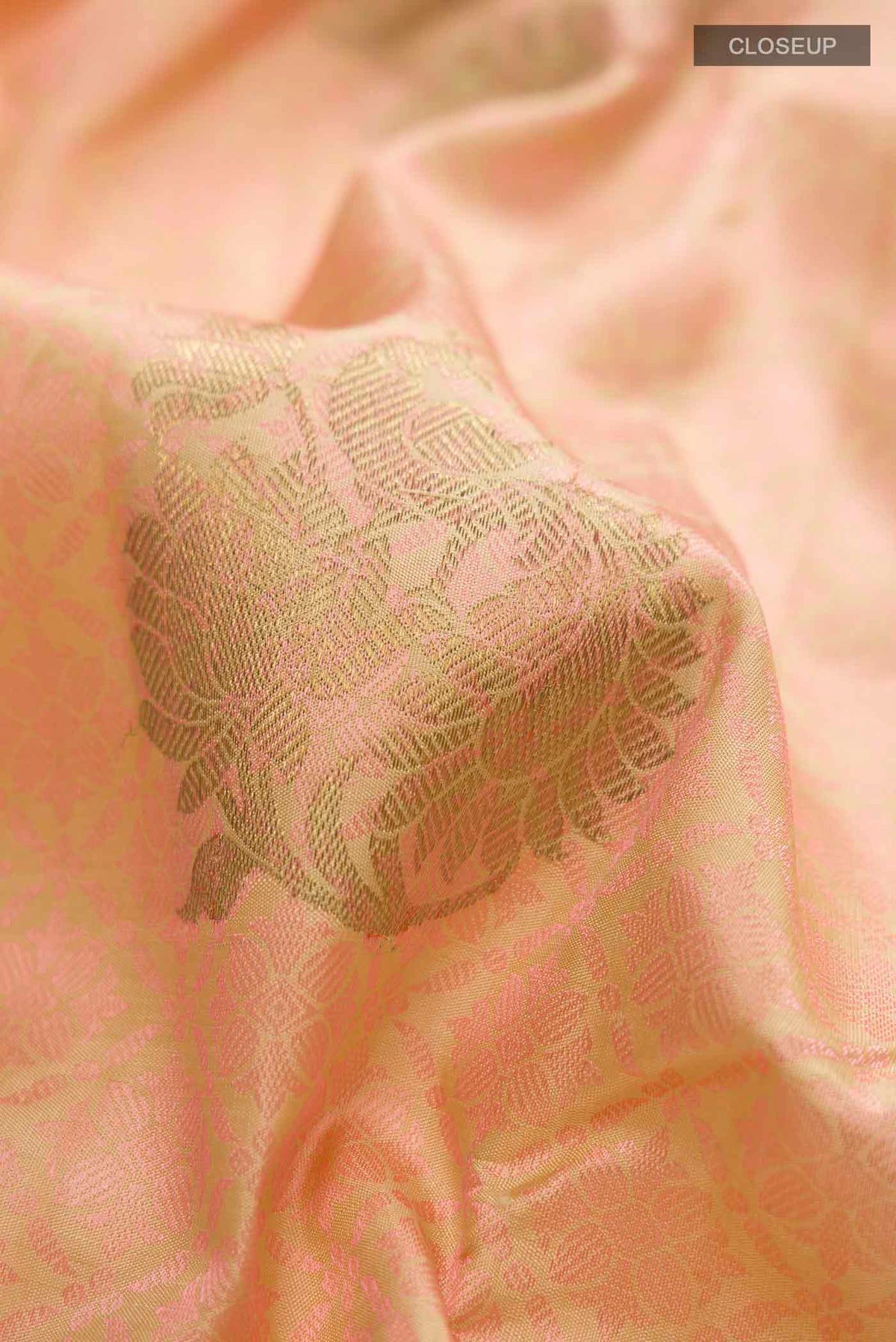 Close up of Pink Kanchipuram Silk Saree with Jacquard With Zari Butta on the body and Zari Border displaying folds