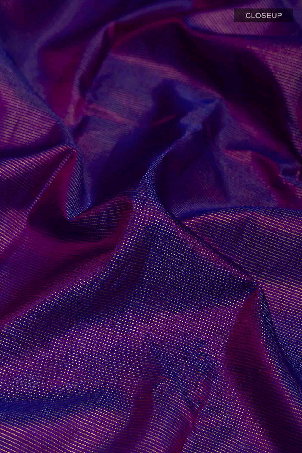 Close up of Violet Kanchipuram Silk Saree with Stripes on the body and Zari Border displaying folds