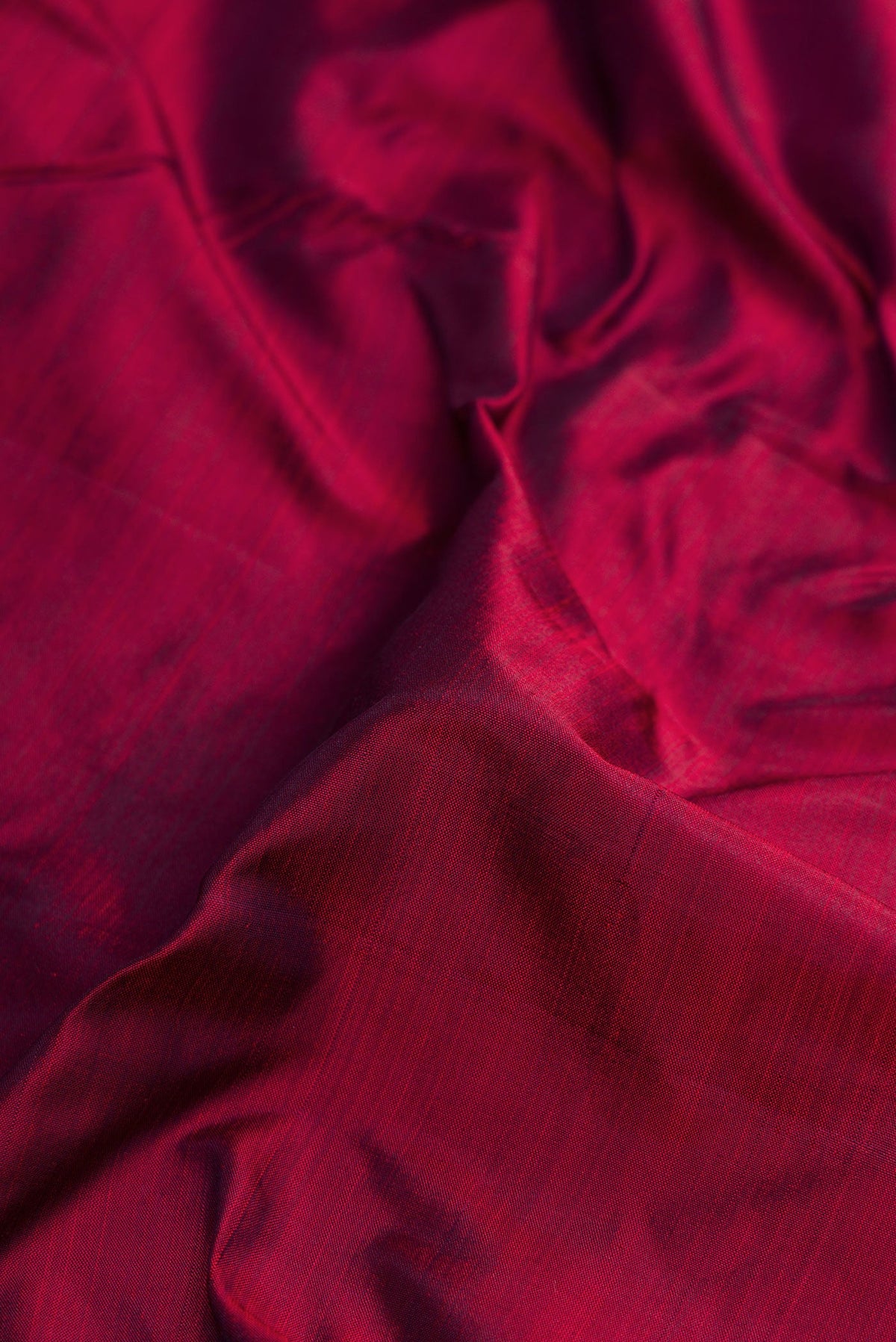 Close up of Pure Silk Pure Zari Maroon Dual Tone Kanjivaram Nine Yards Saree with Plain Body and Zari Border.  displaying folds