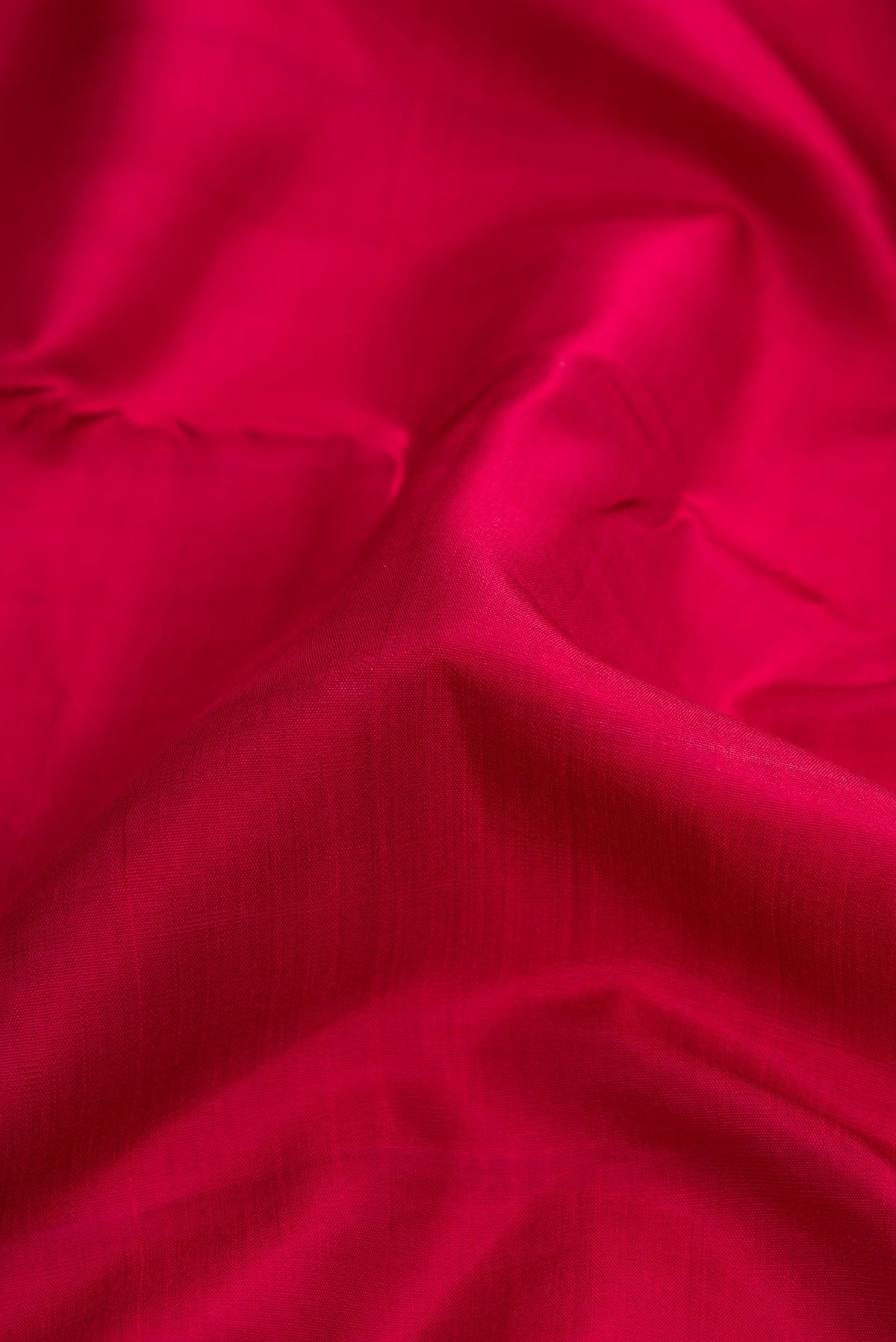 Close up of Maroon Dual Tone Kanjivaram Silk Nine Yards Saree with Plain Body and Zari Border.  displaying folds