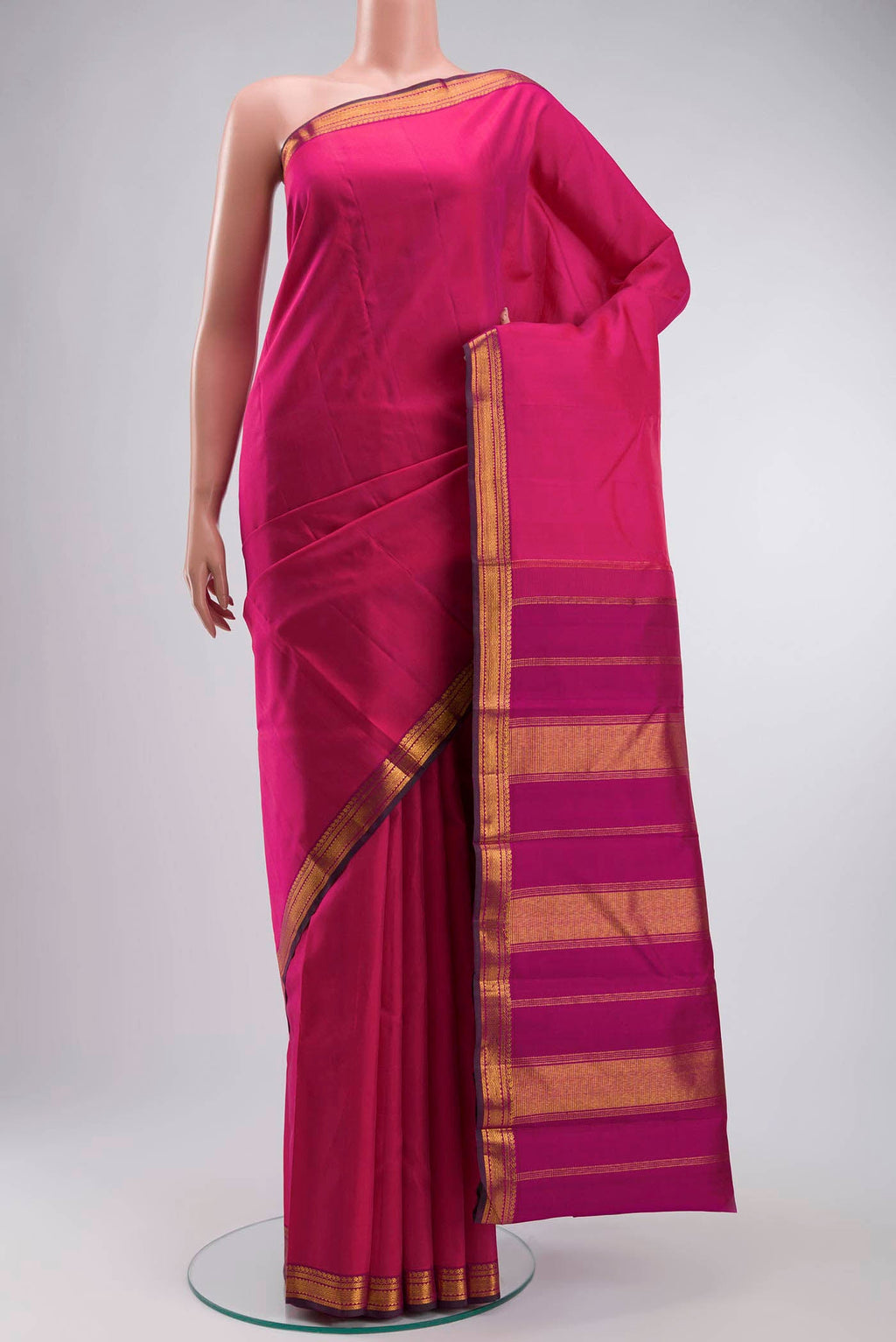 Pink Kanchipuram Silk Saree with Plain Body and Zari Border displayed on a mannequin
