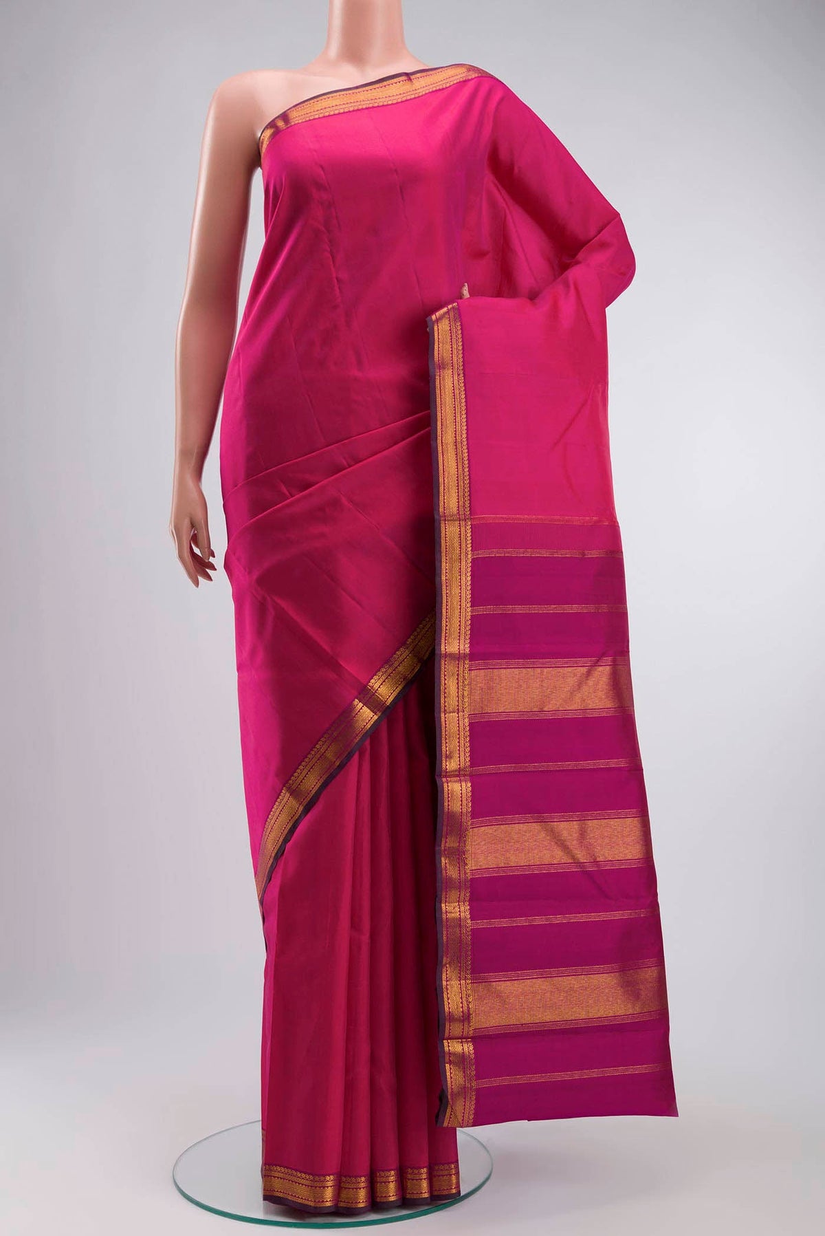 Pink Kanchipuram Silk Saree with Plain Body and Zari Border displayed on a mannequin