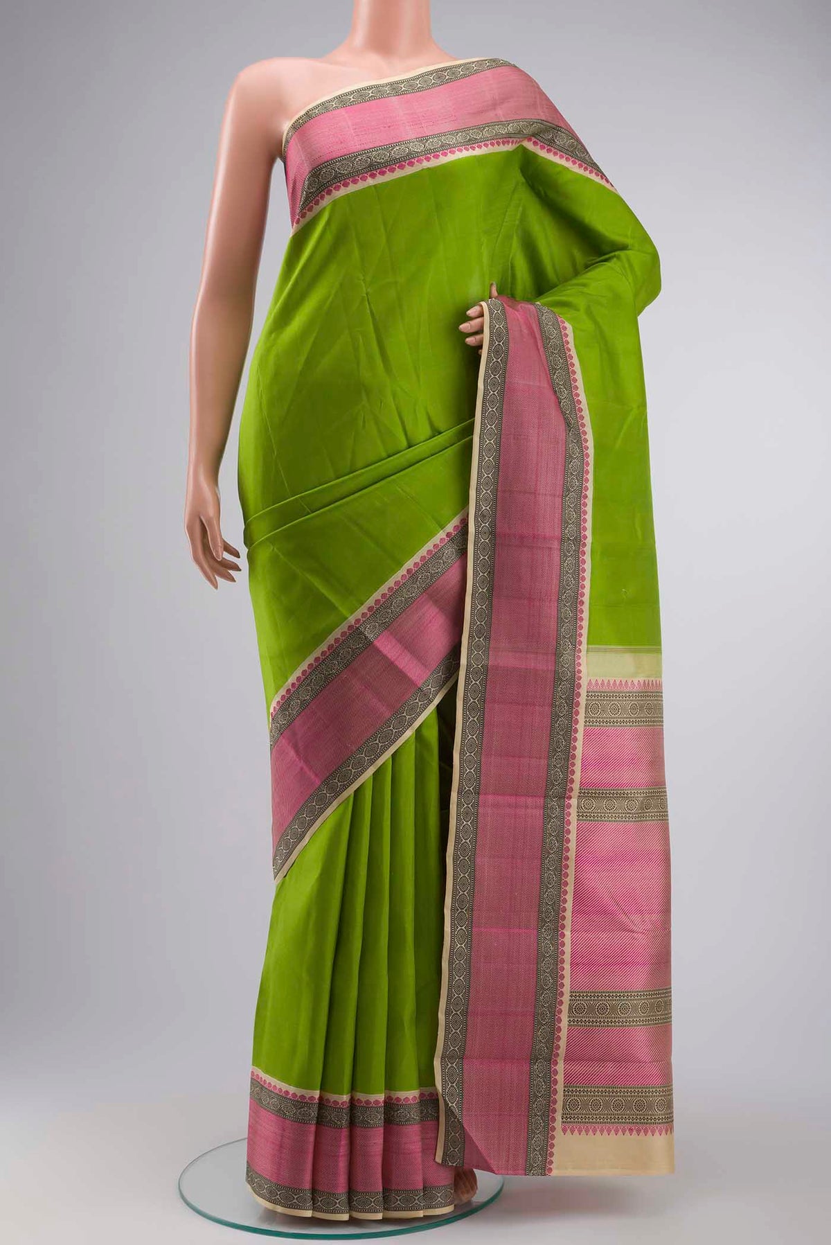 Green Kanchipuram Silk Saree with Plain Body and Thread Border displayed on a mannequin