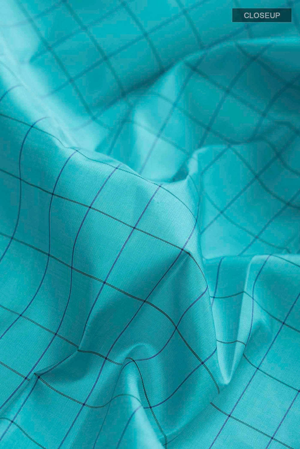 Close up of Blue Kanchipuram Silk Saree with Checked design on the body and Zari Border displaying folds