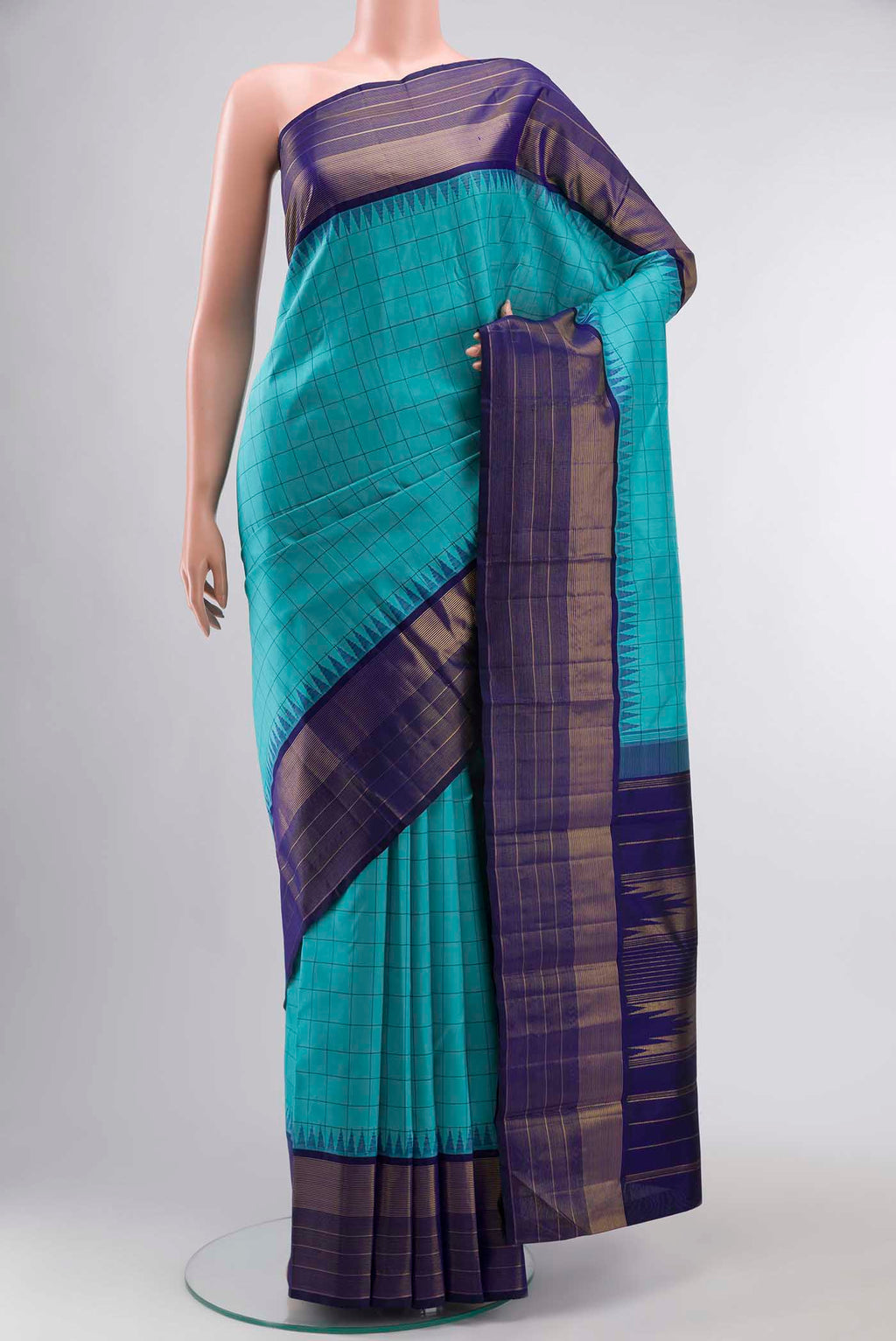 Blue Kanchipuram Silk Saree with Checked design on the body and Zari Border displayed on a mannequin