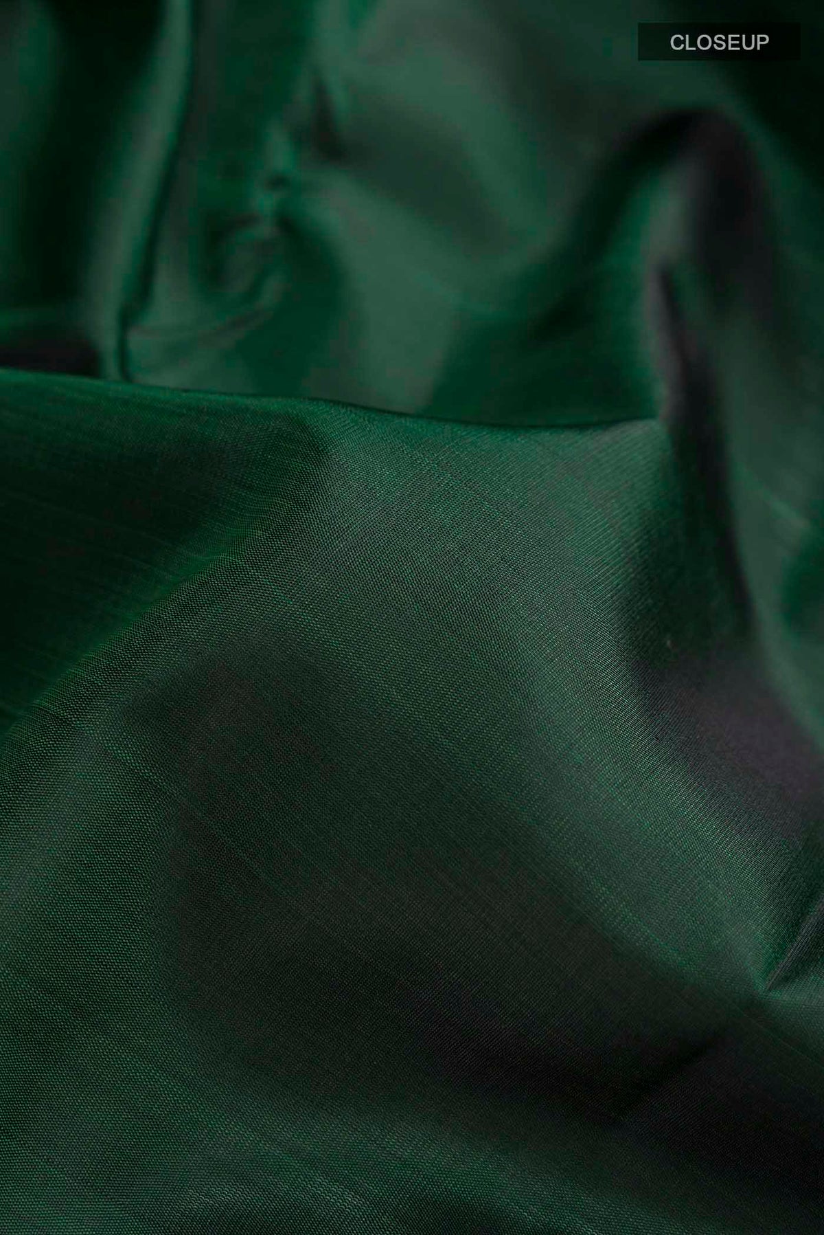 Close up of Green Kanchipuram Silk Saree with Plain Body and Temple Border displaying folds