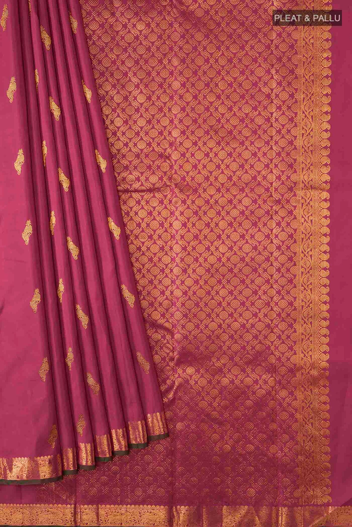 Pleats and pallu of Maroon Kanchipuram Silk Saree with Zari Butta on the body and Zari Border