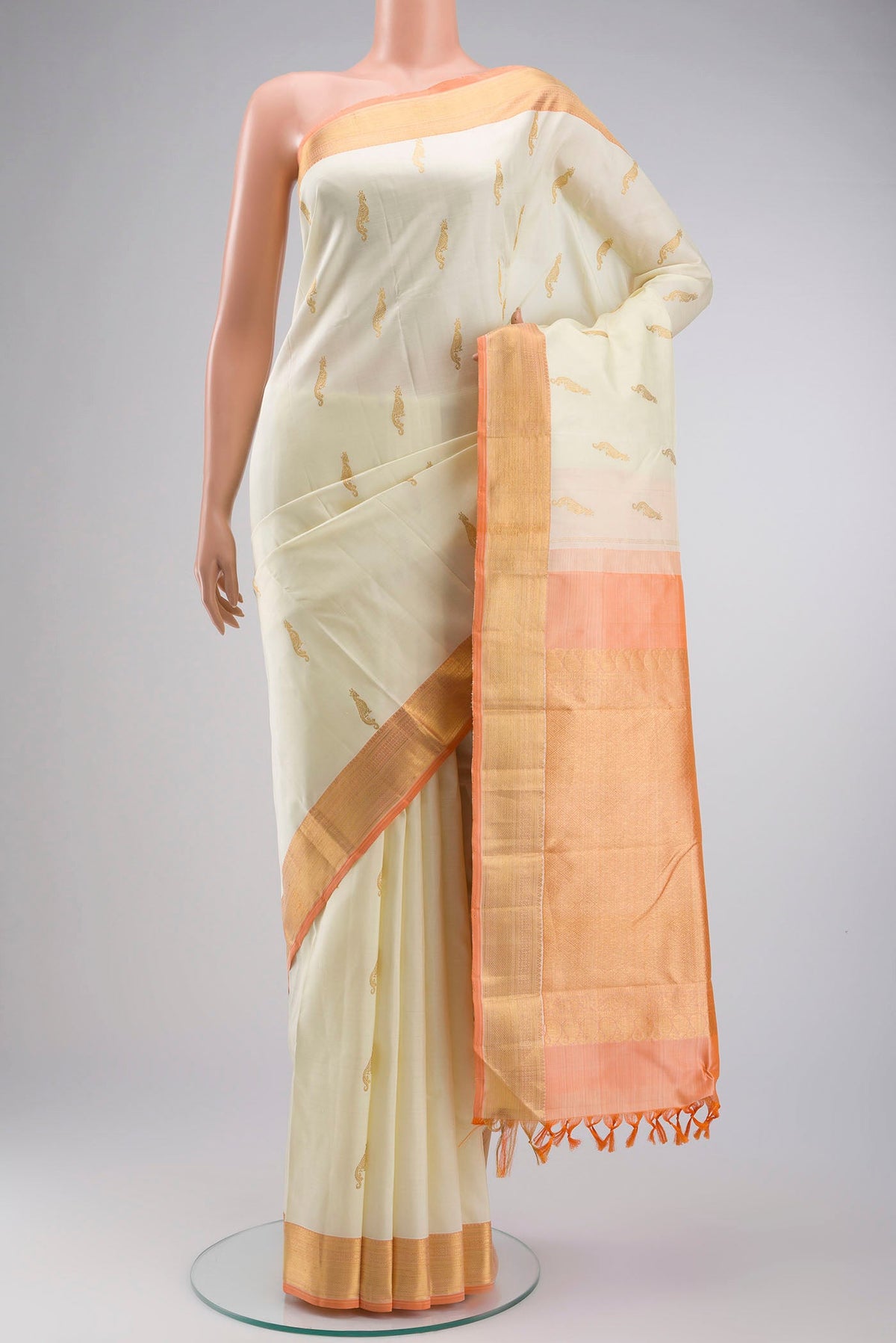 Cream Kanchipuram Silk Saree with Zari Butta on the body and Zari Border displayed on a mannequin