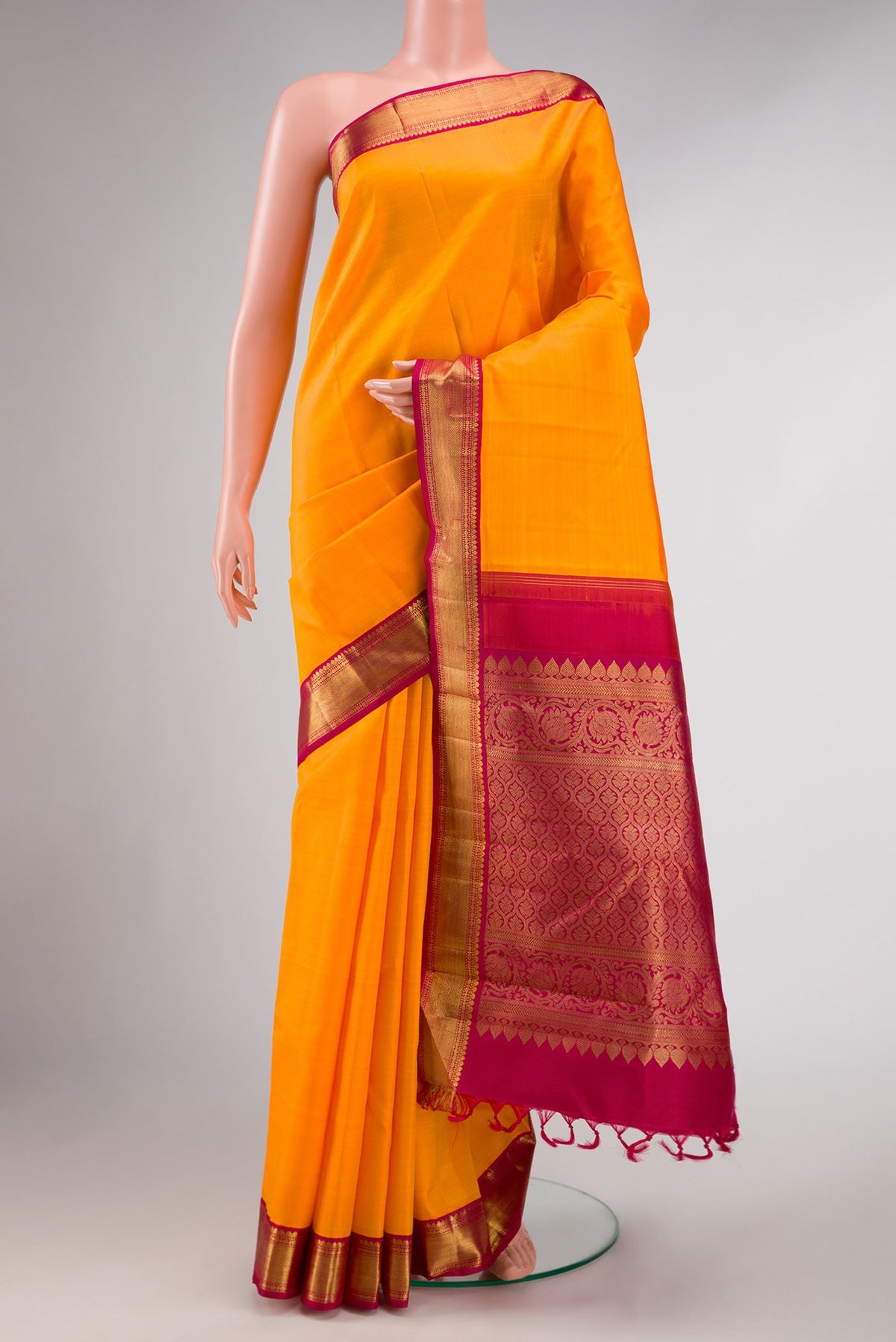 Pure Silk Pure Zari Orange Dual Tone Kanchipuram Saree with Plain Body and Zari Border displayed on a mannequin