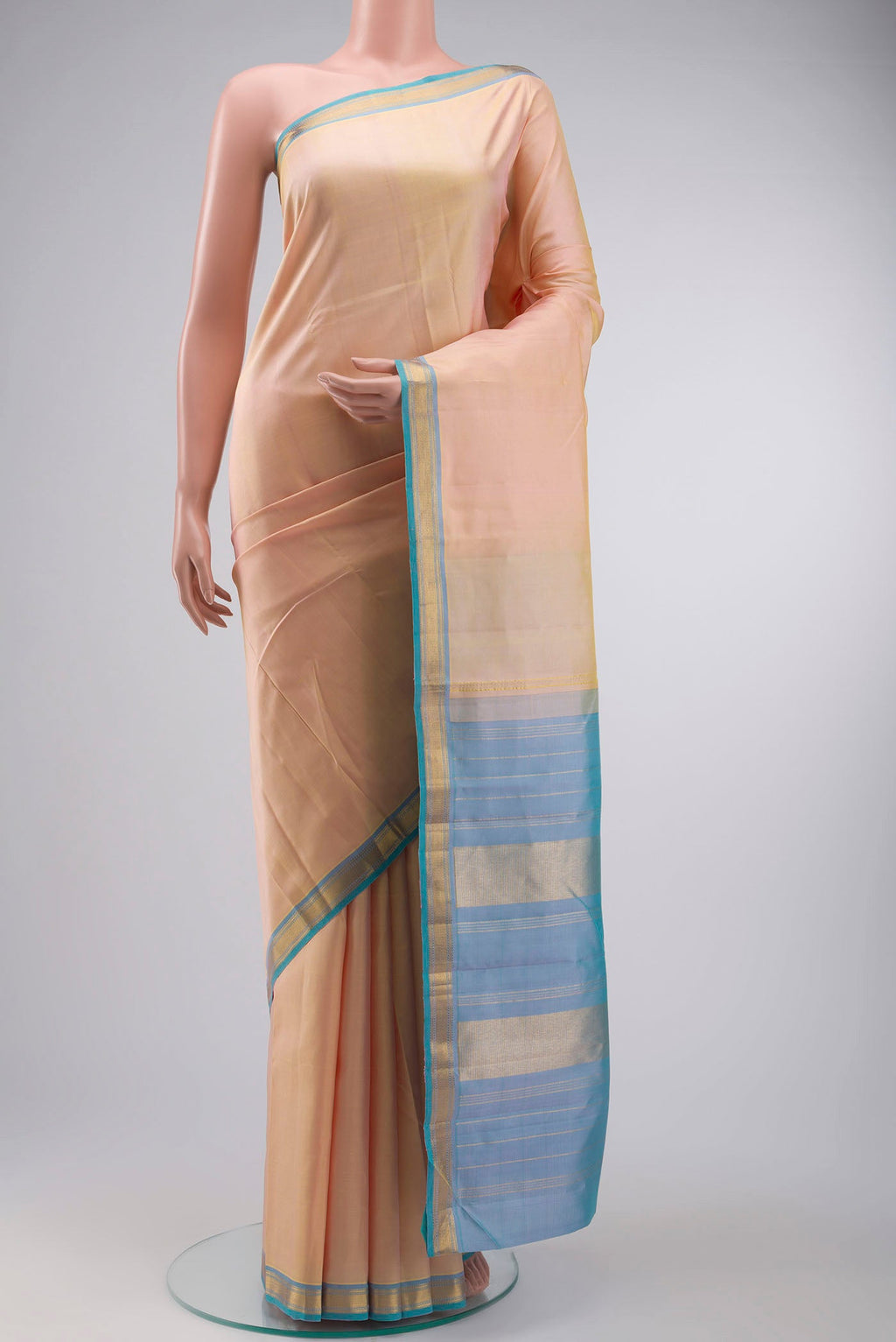 Rose Gold Kanchipuram Silk Saree with Plain Body and Zari Border displayed on a mannequin