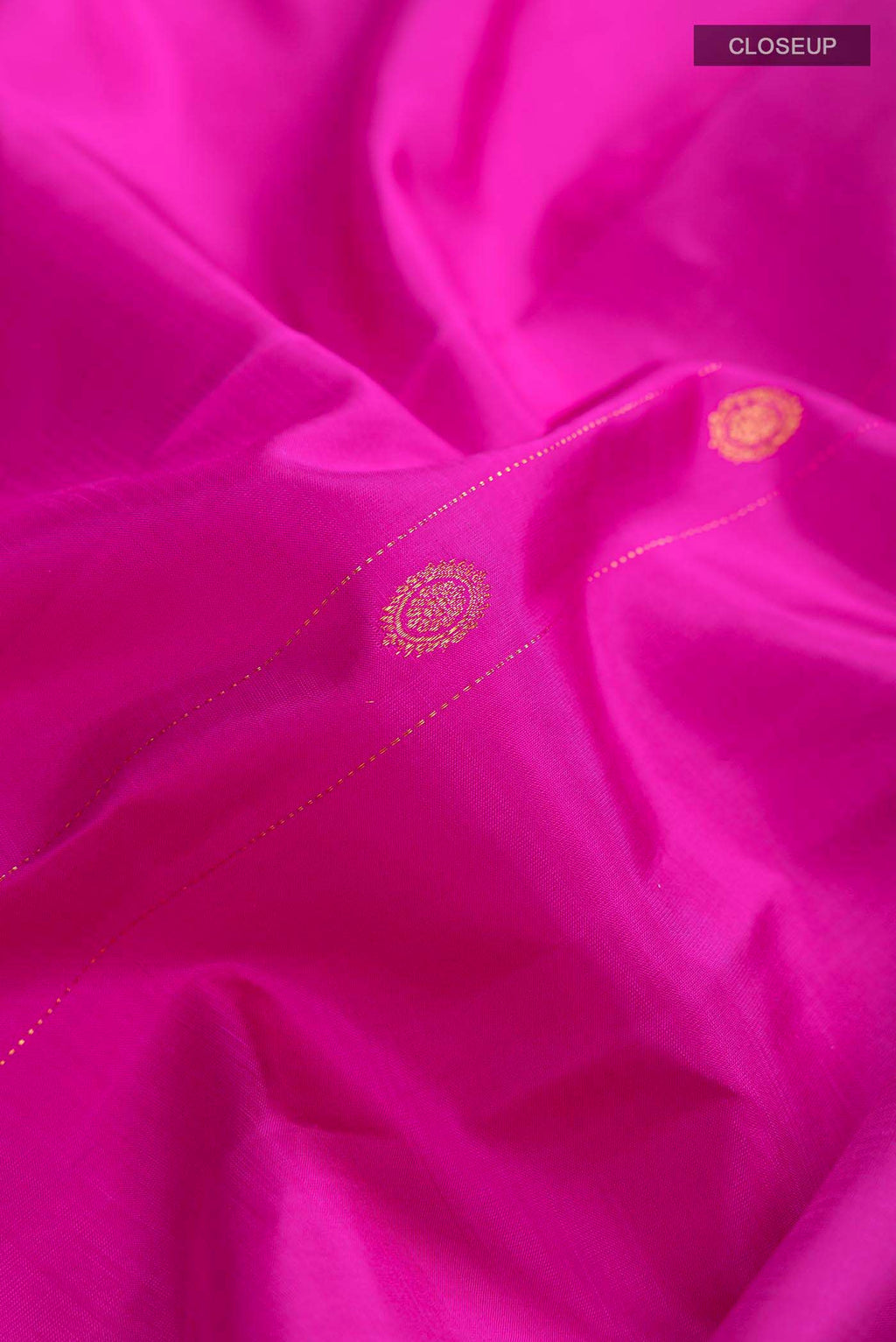 Close up of Pink Kanchipuram Silk Saree with Zari Butta on the body and Without Border displaying folds