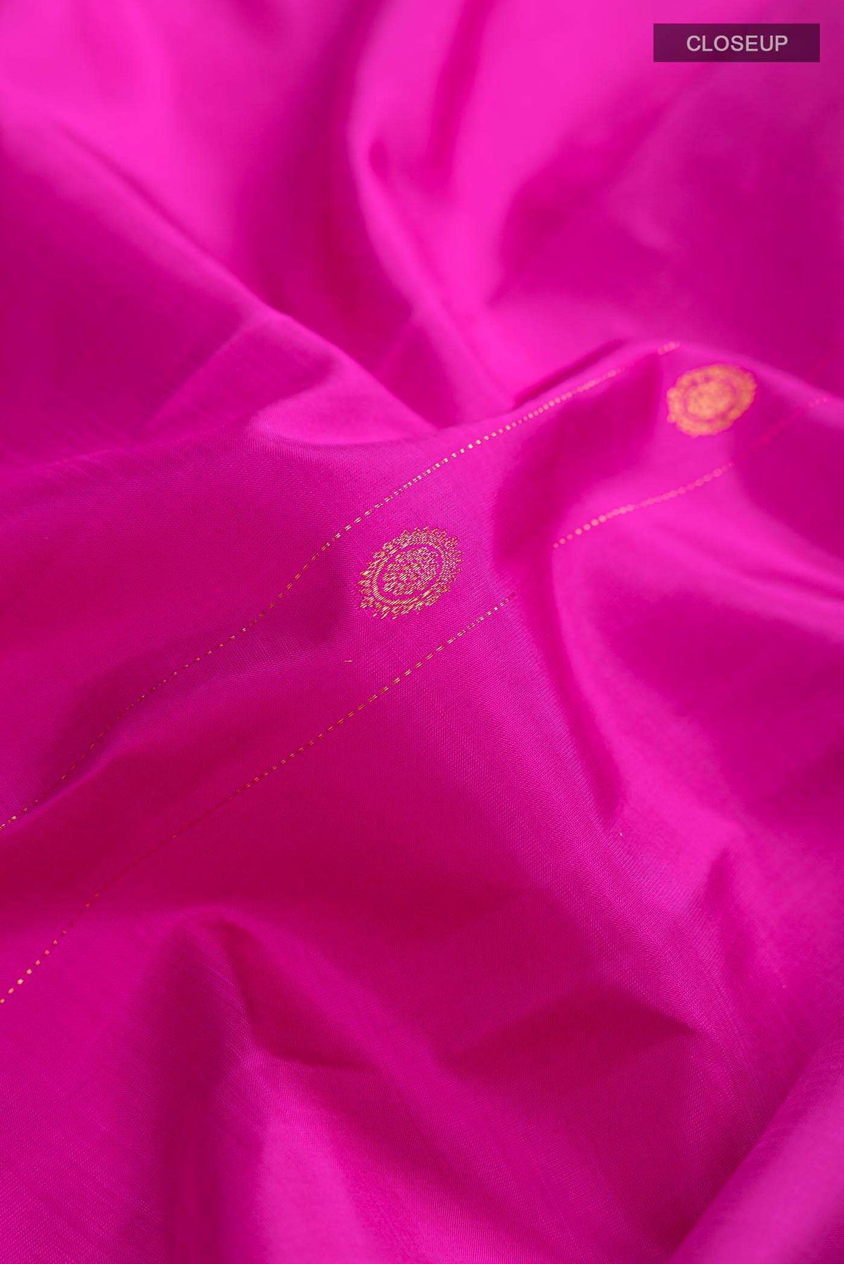 Close up of Pink Kanchipuram Silk Saree with Zari Butta on the body and Without Border displaying folds