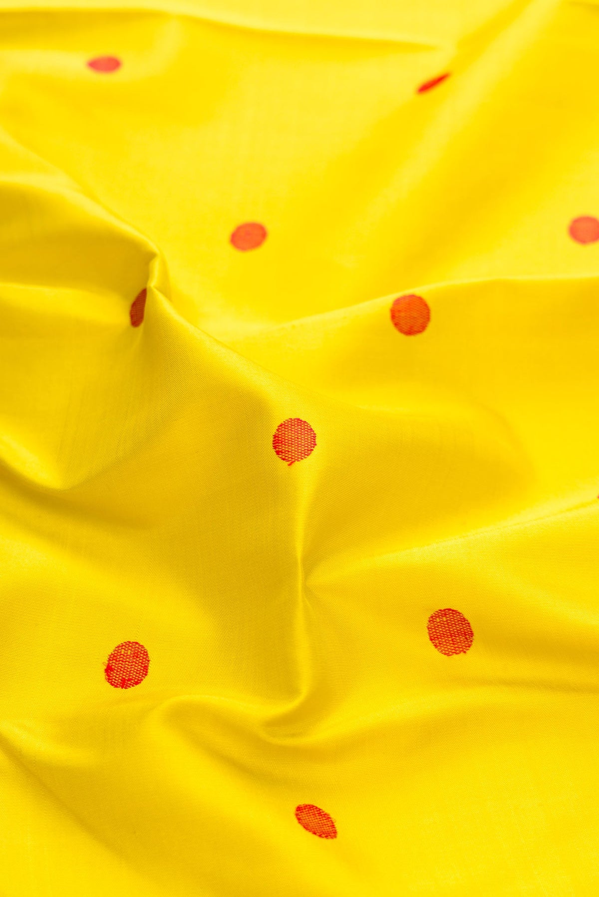 Close up of Lemon Yellow Dual Tone Kanchipuram Silk Saree with Thread Butta on the body and Zari Border displaying folds