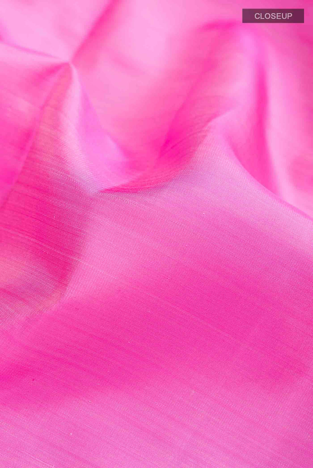 Close up of Pink Kanchipuram Silk Saree with Plain Body and Zari Border displaying folds