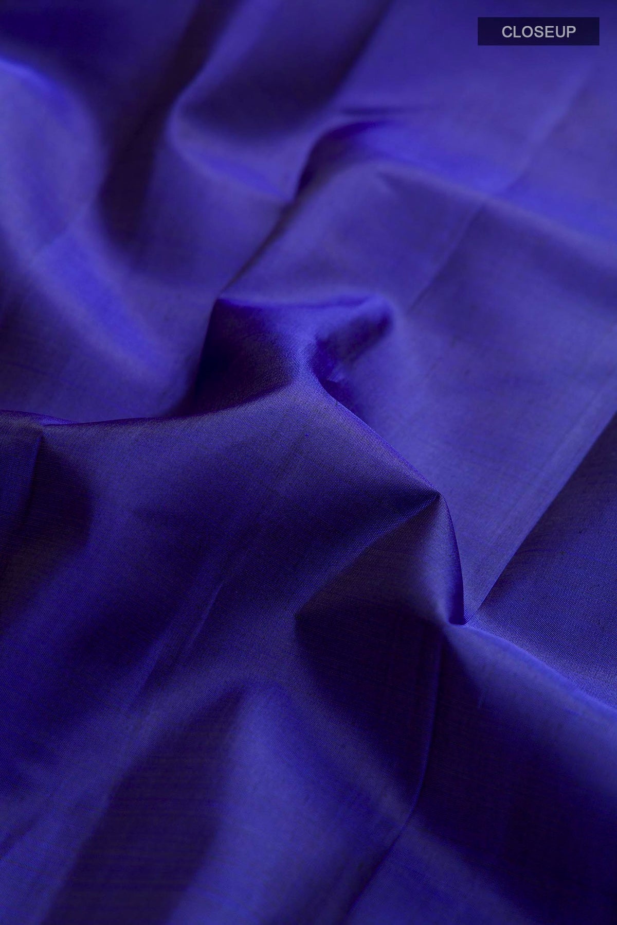 Close up of Blue Kanchipuram Silk Saree with Plain Body and Zari Border displaying folds
