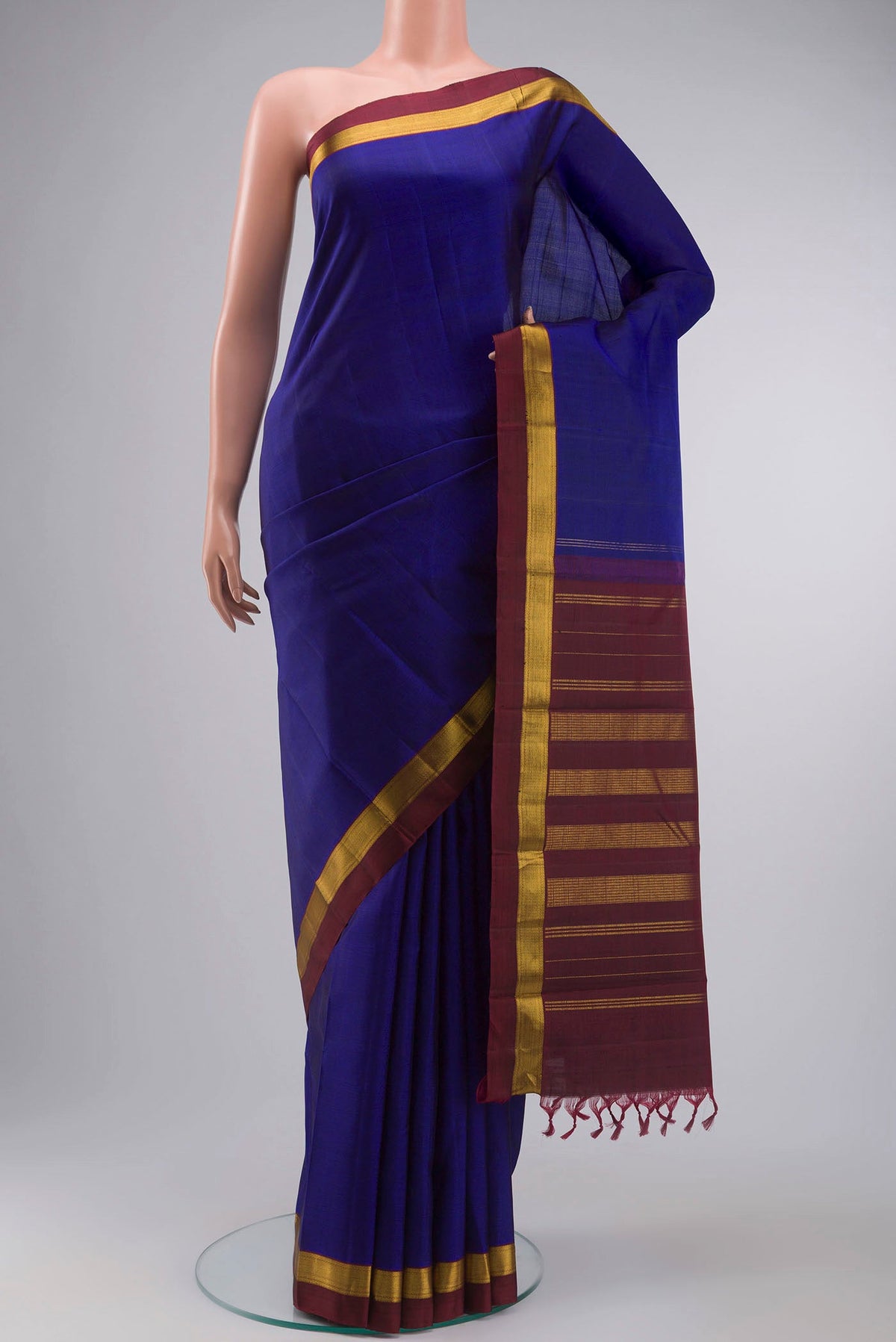 Blue Kanchipuram Silk Saree with Plain Body and Zari Border displayed on a mannequin