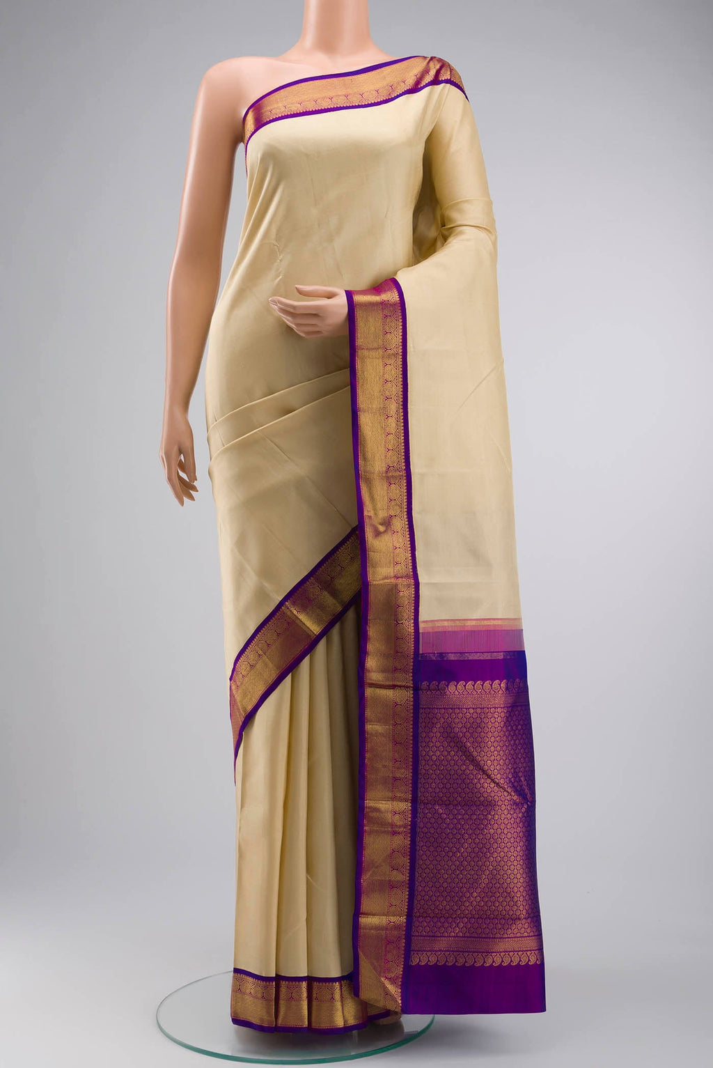 Cream Kanchipuram Silk Saree with Plain Body and Zari Border displayed on a mannequin