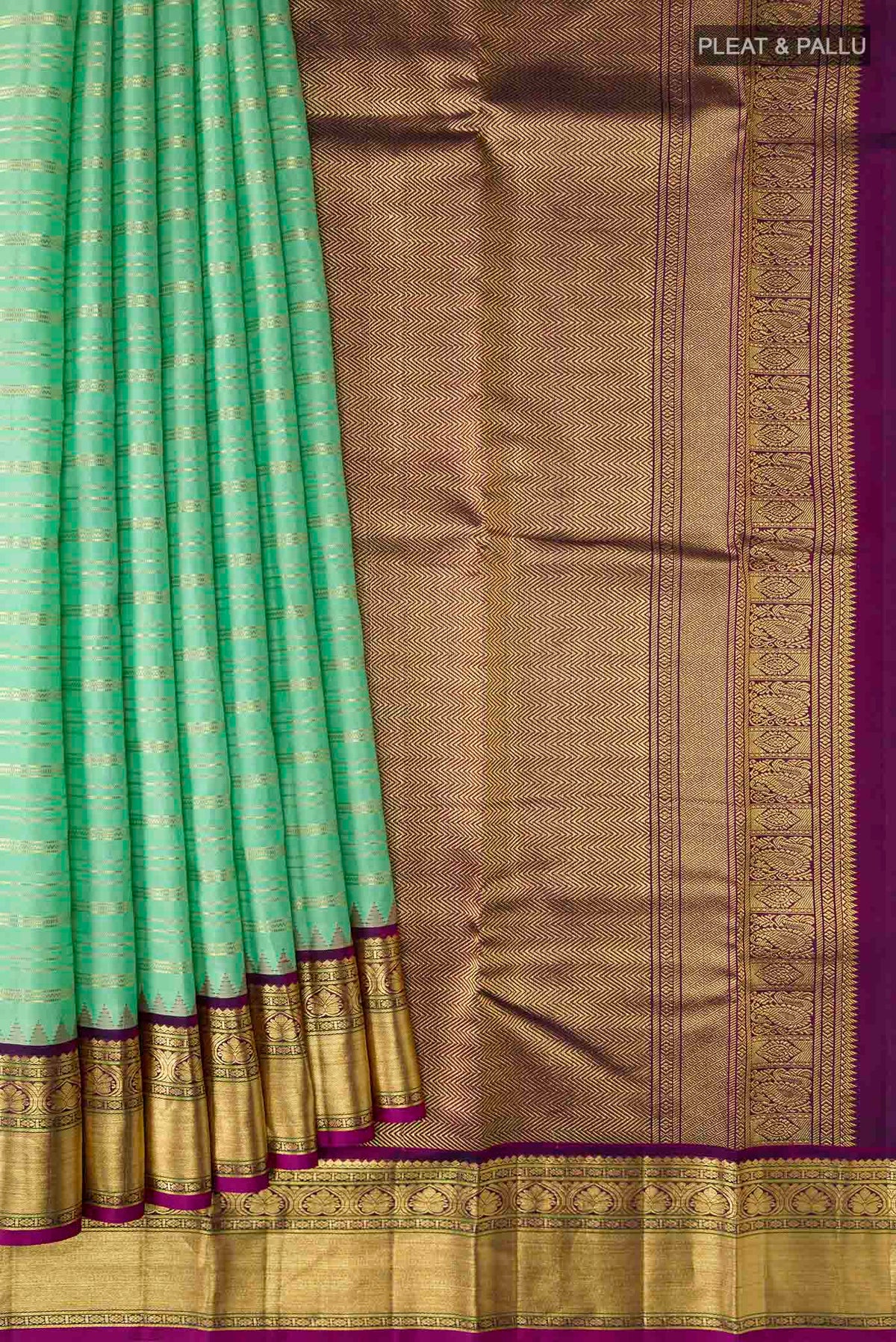 Pleats and pallu of Green Kanchipuram Silk Saree with Stripes on the body and Zari Border