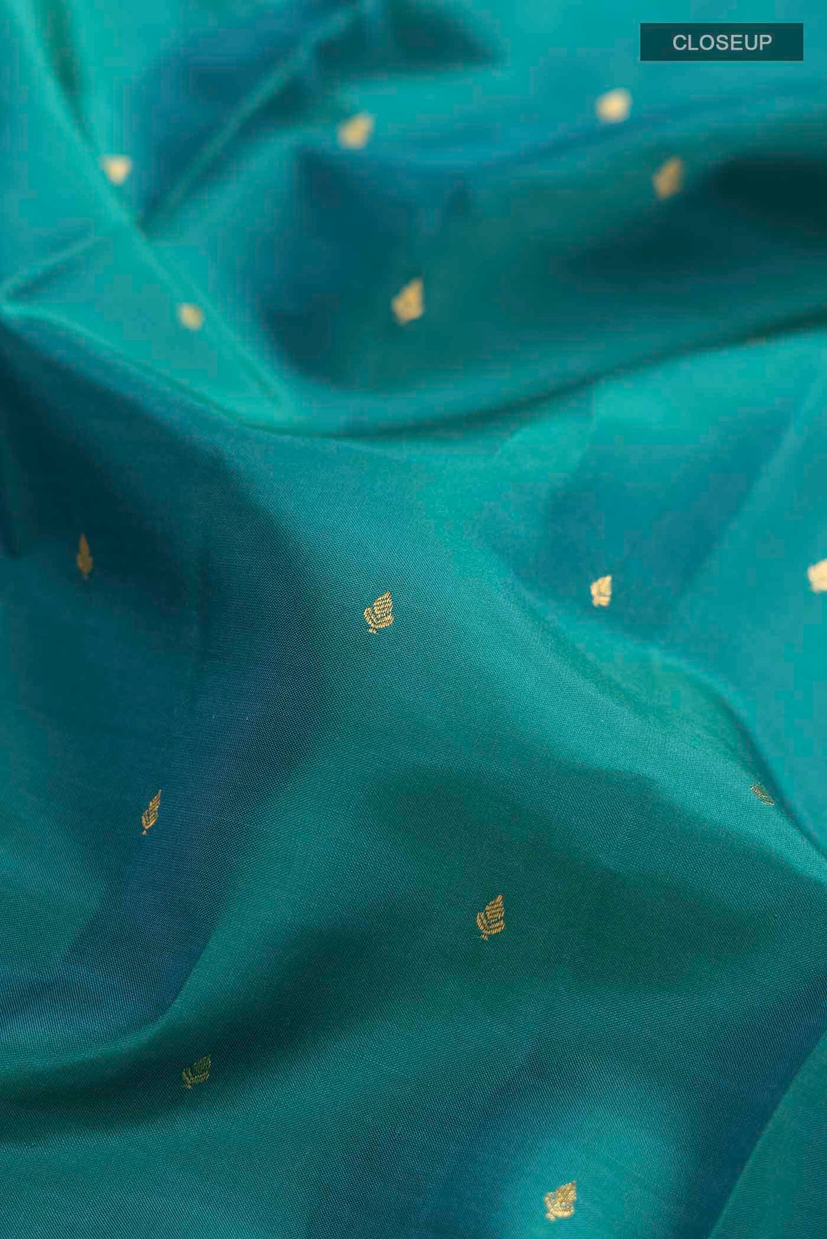 Close up of Blue Kanchipuram Silk Saree with Zari Butta on the body and Zari Border displaying folds