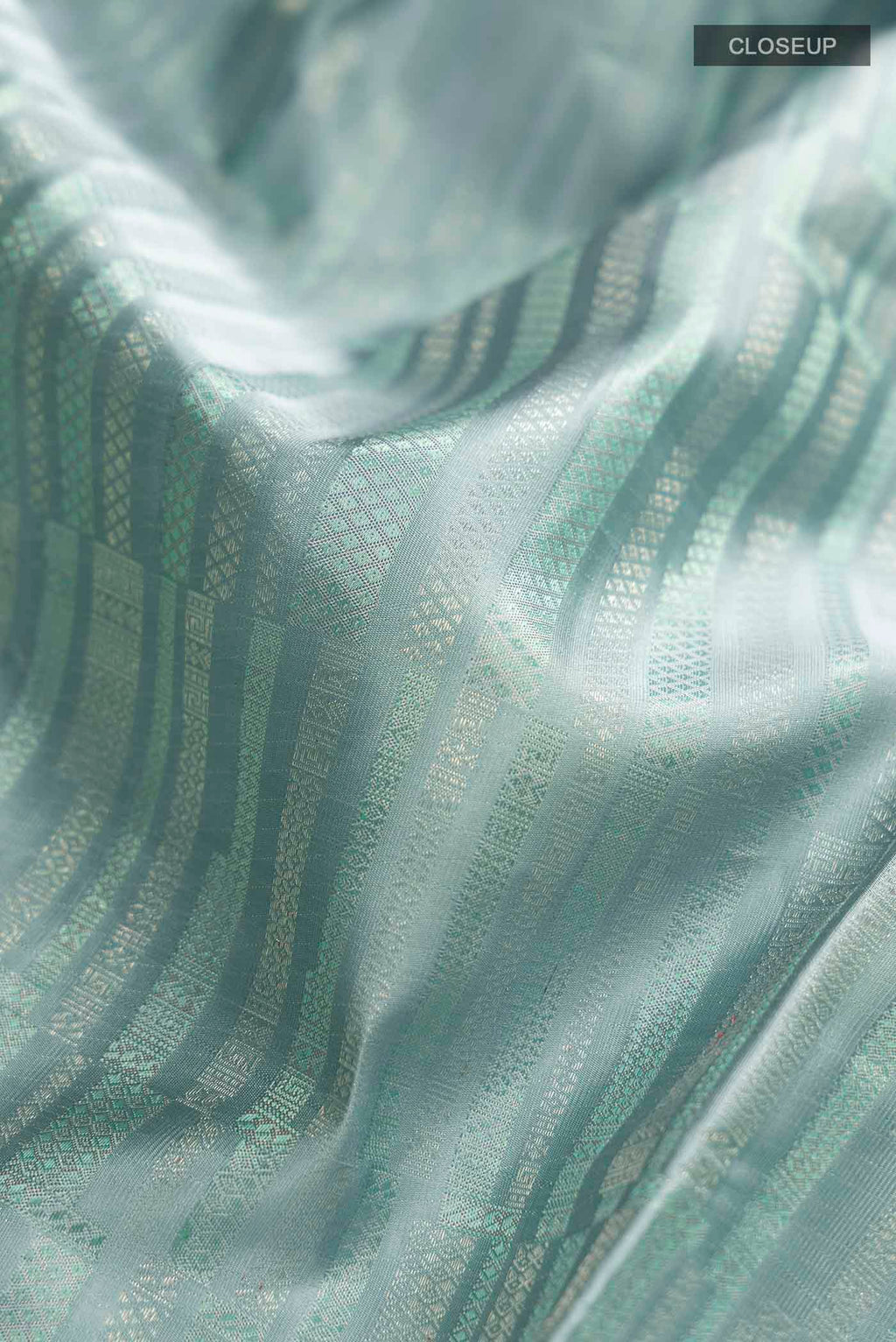 Close up of Blue Grey Kanchipuram Silk Saree with Stripes on the body and Zari Border displaying folds