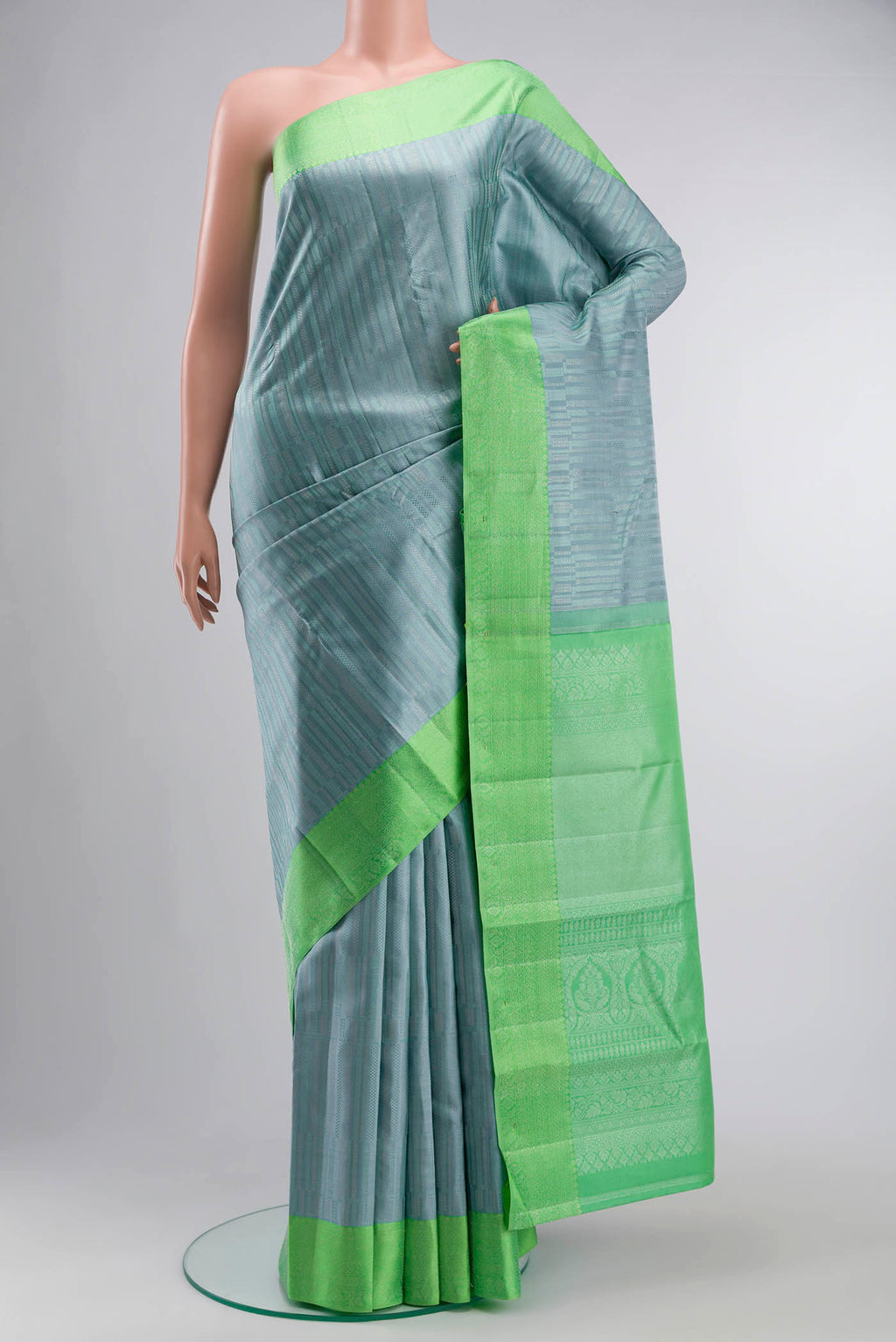 Blue Grey Kanchipuram Silk Saree with Stripes on the body and Zari Border displayed on a mannequin