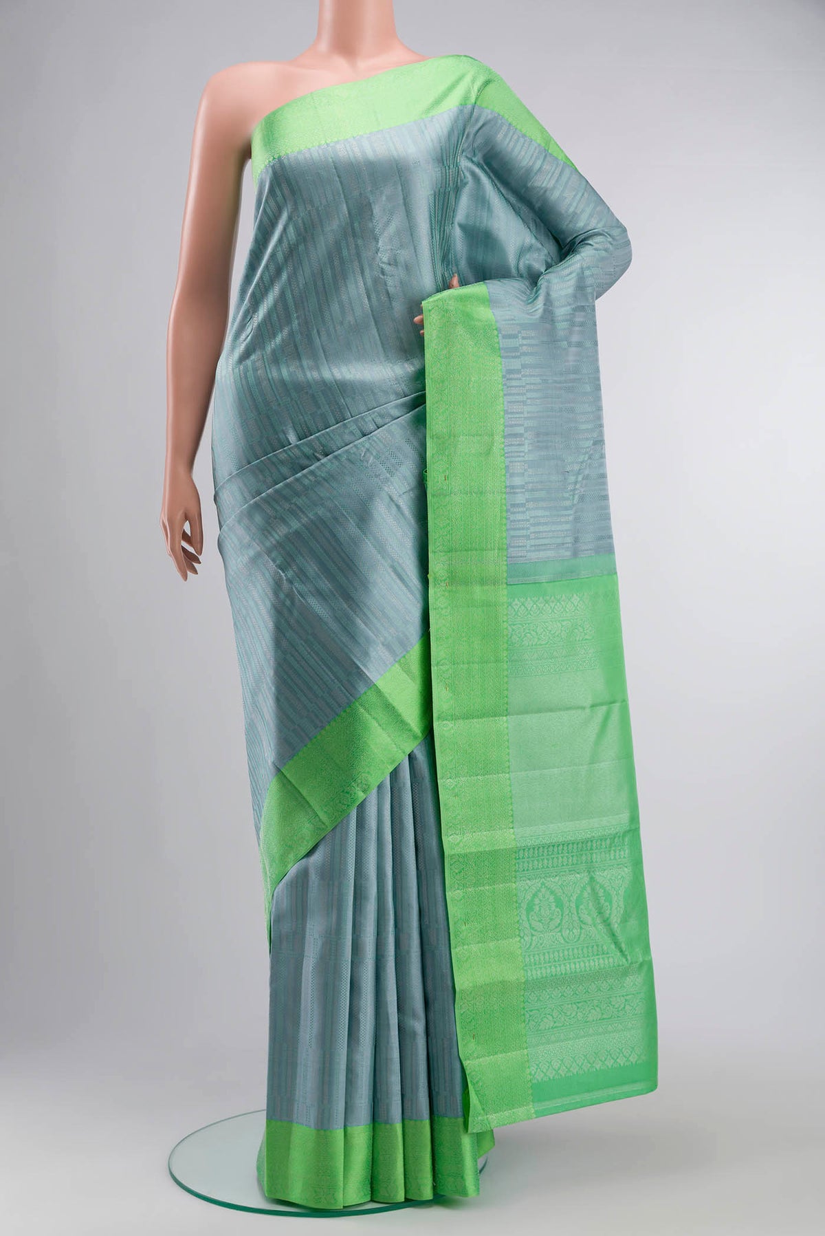 Blue Grey Kanchipuram Silk Saree with Stripes on the body and Zari Border displayed on a mannequin