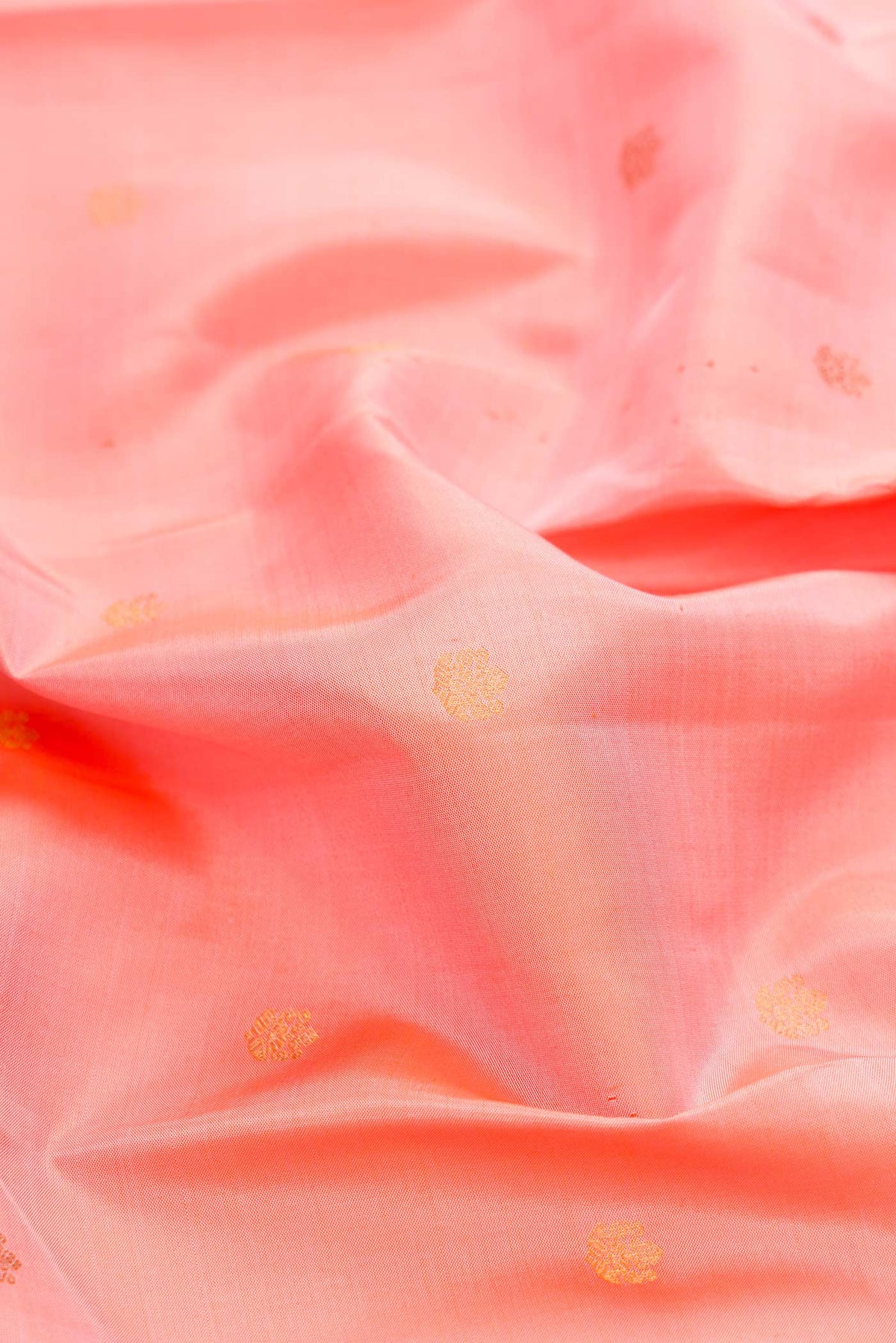 Close up of Pink Dual Tone Kanchipuram Silk Saree with Zari Butta on the body and Zari Border displaying folds