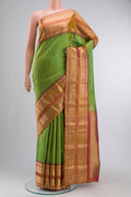 Green Kanchipuram Silk Saree with Zari Butta on the body and Zari Border displayed on a mannequin
