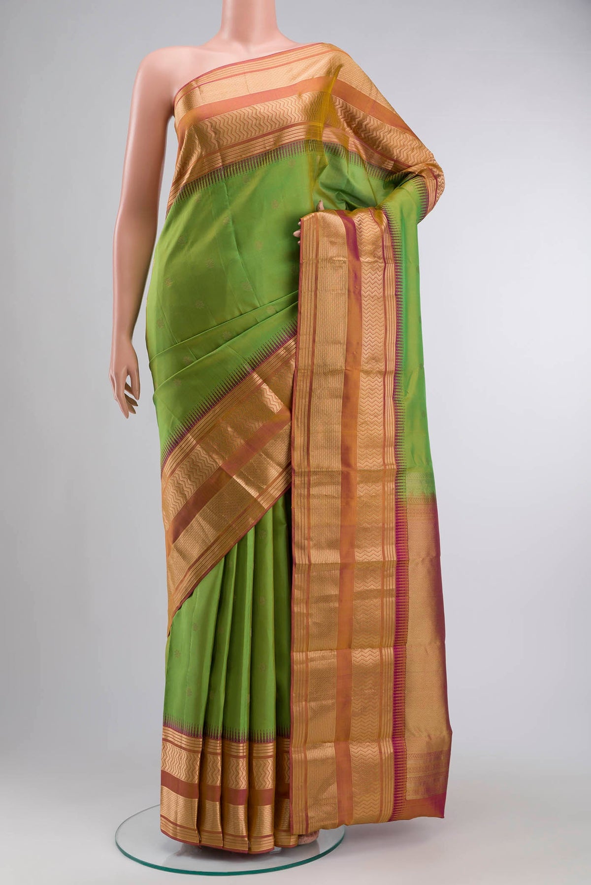 Green Kanchipuram Silk Saree with Zari Butta on the body and Zari Border displayed on a mannequin