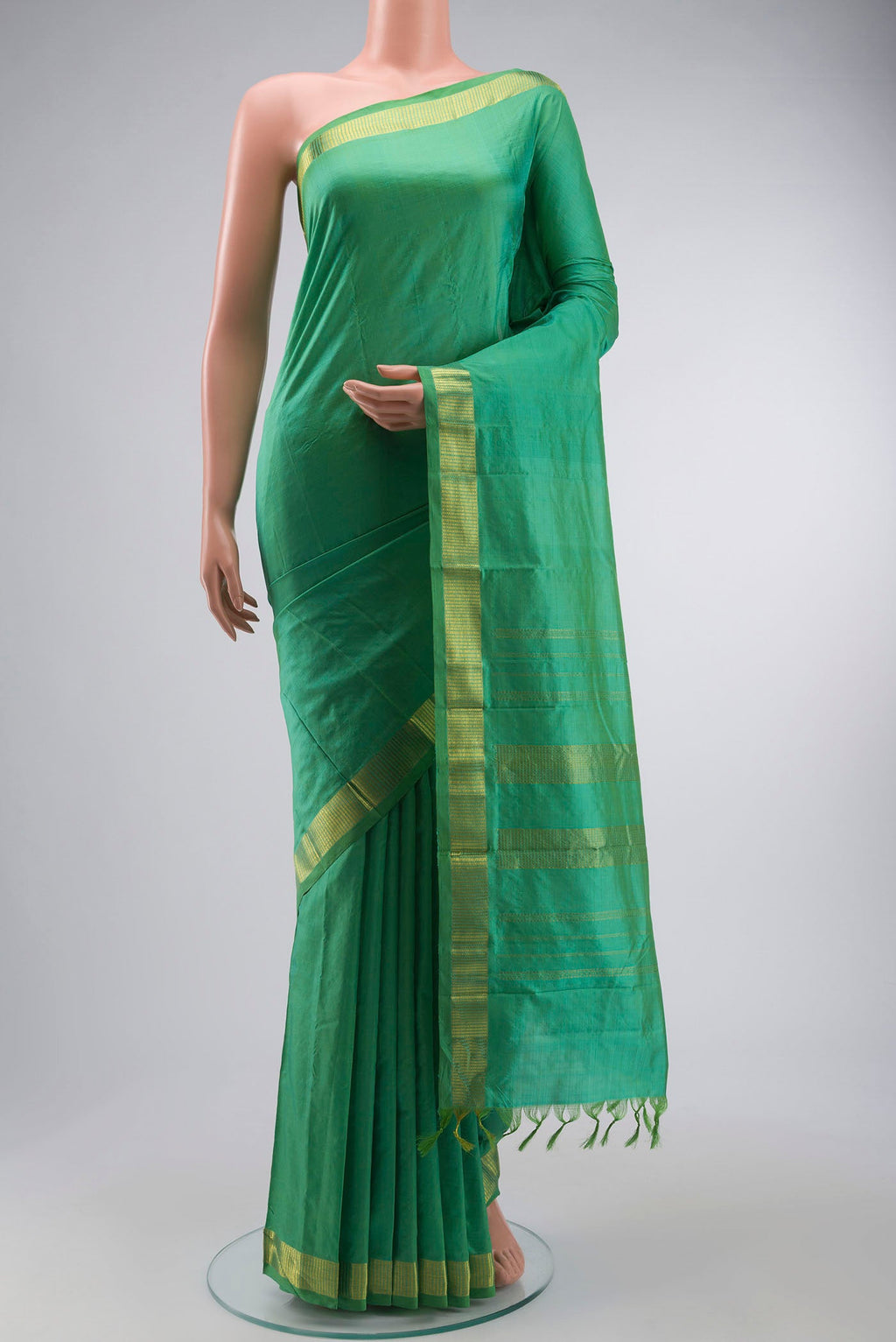 Green Kanchipuram Silk Saree with Plain Body and Zari Border displayed on a mannequin