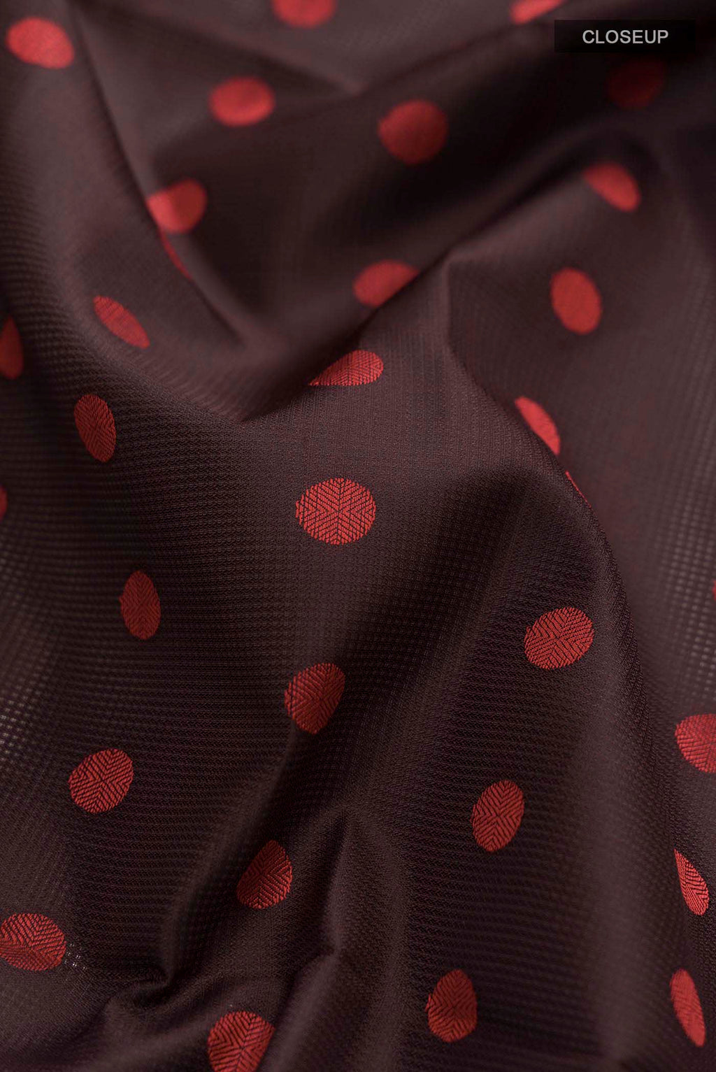 Close up of Brown Soft Silk Saree with Thread Butta on the body and Thread Border displaying folds