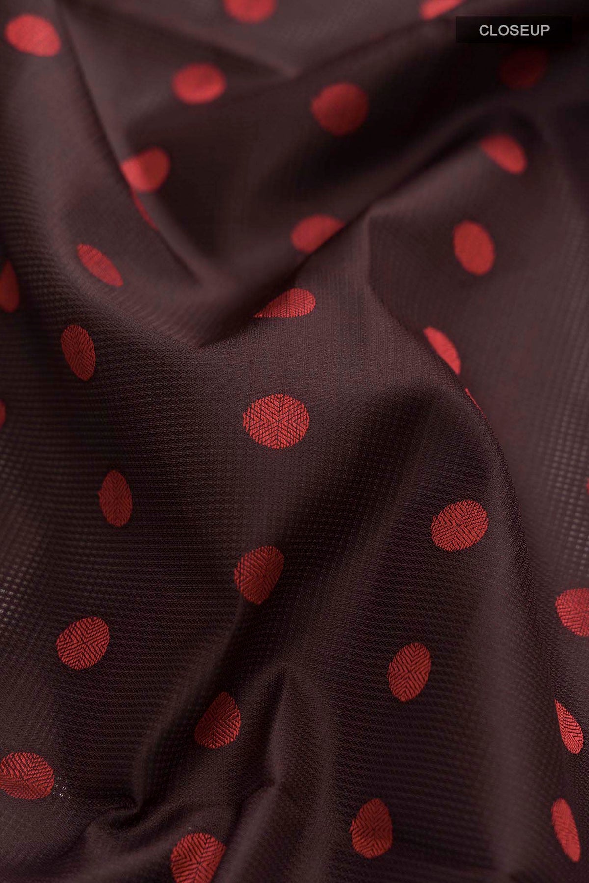 Close up of Brown Soft Silk Saree with Thread Butta on the body and Thread Border displaying folds