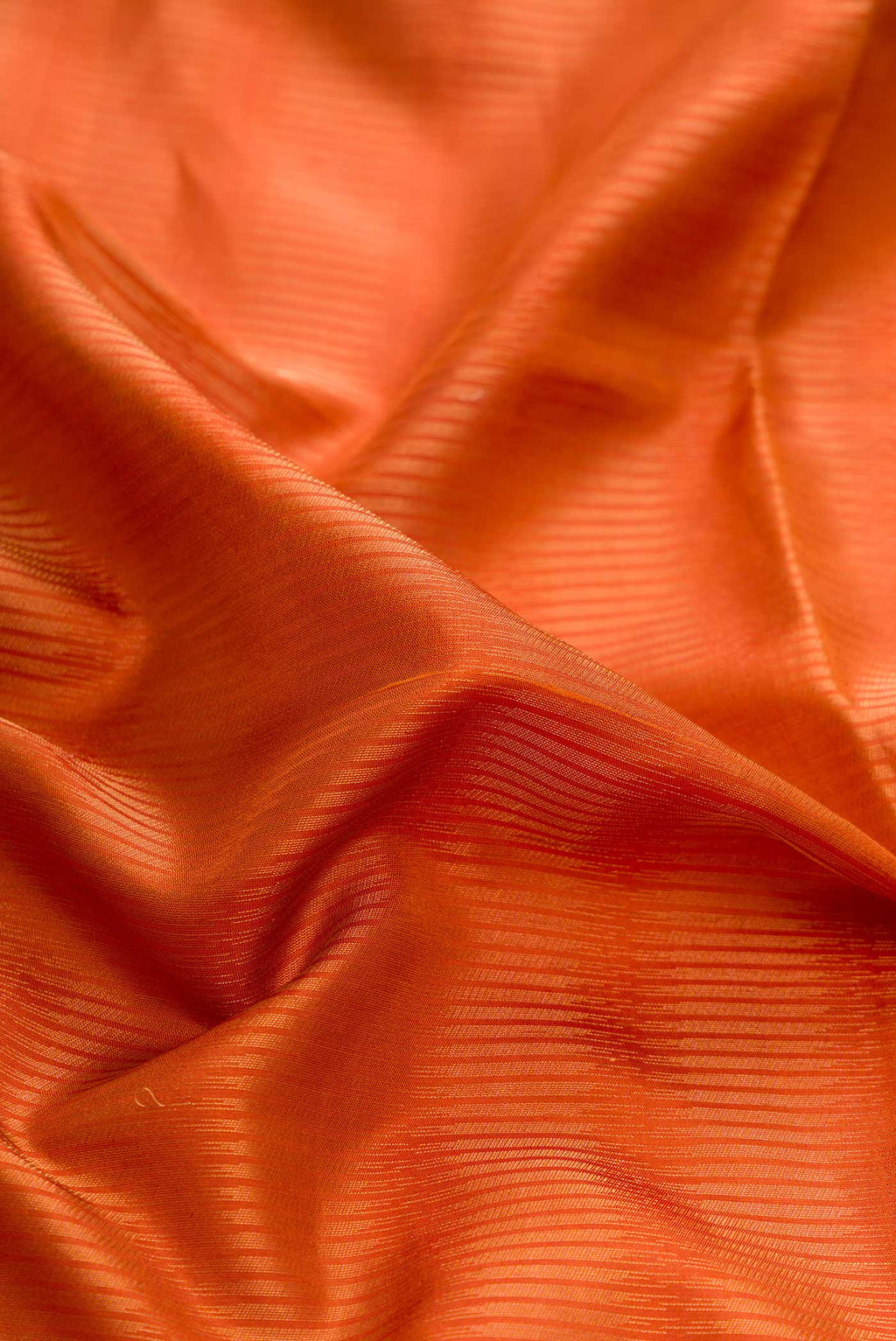 Close up of Mustard Dual Tone Soft Silk Saree with Stripes on the body and Zari Border displaying folds
