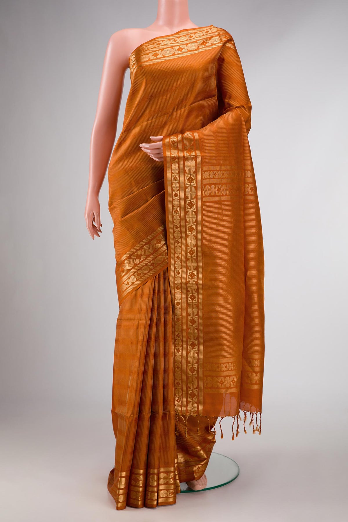 Mustard Dual Tone Soft Silk Saree with Stripes on the body and Zari Border displayed on a mannequin