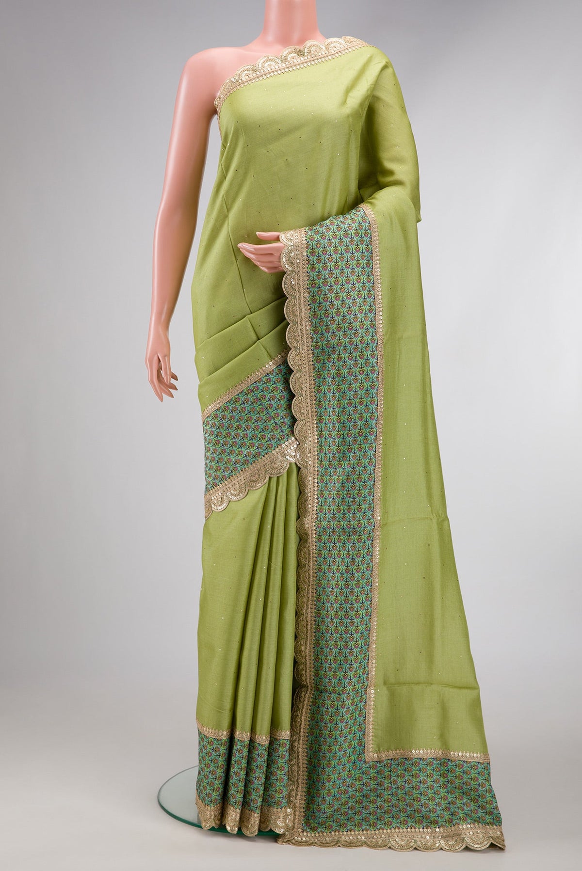 Pista Green Dual Tone Tussar Silk Saree with Embroidery on the body and Fancy Border.  displayed on a mannequin