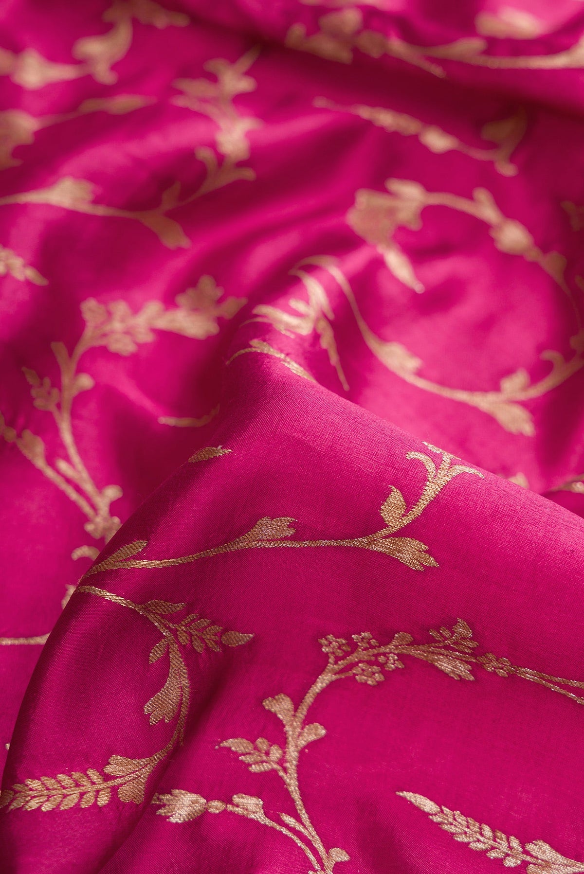 Close up of Magenta Dual Tone Tussar Silk Saree with Zari Brocade on the body and Fancy Border.  displaying folds