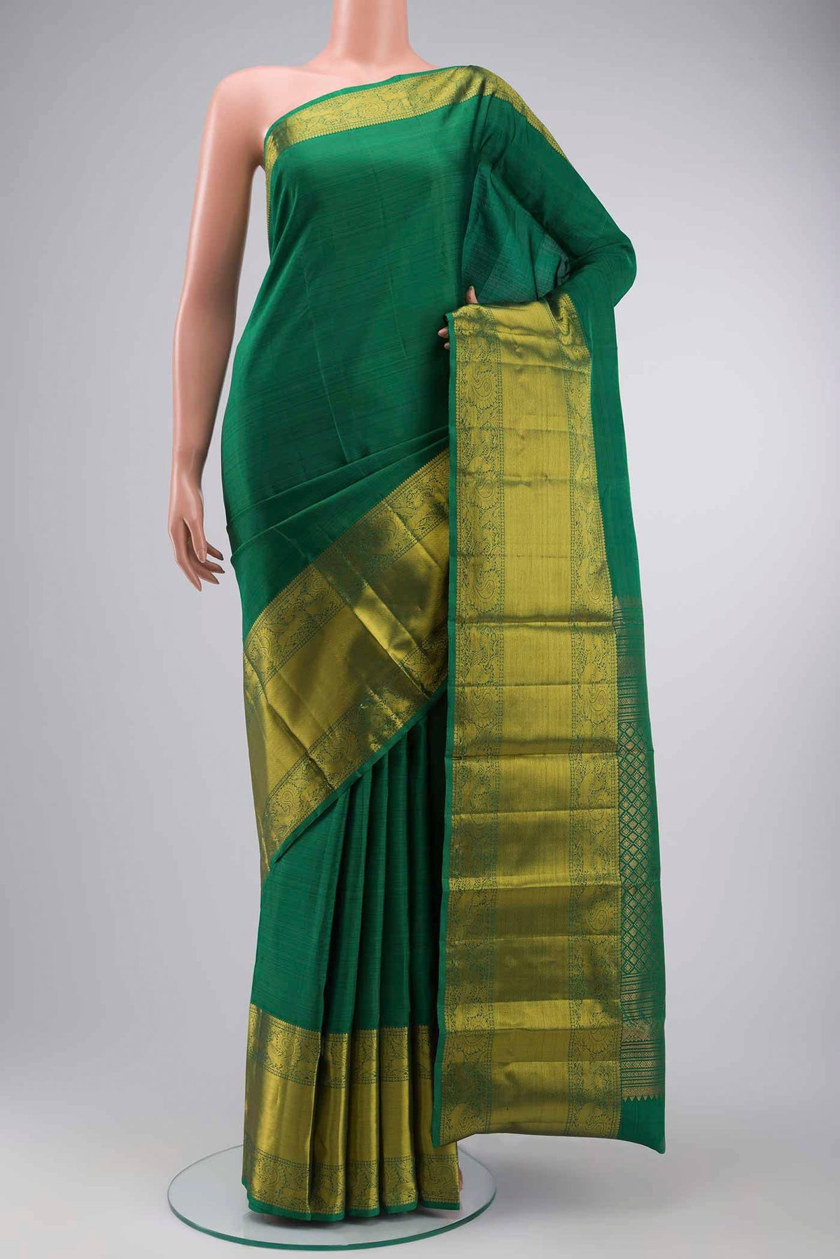 Green Kanchipuram Silk Saree with Plain Body and Zari Border displayed on a mannequin
