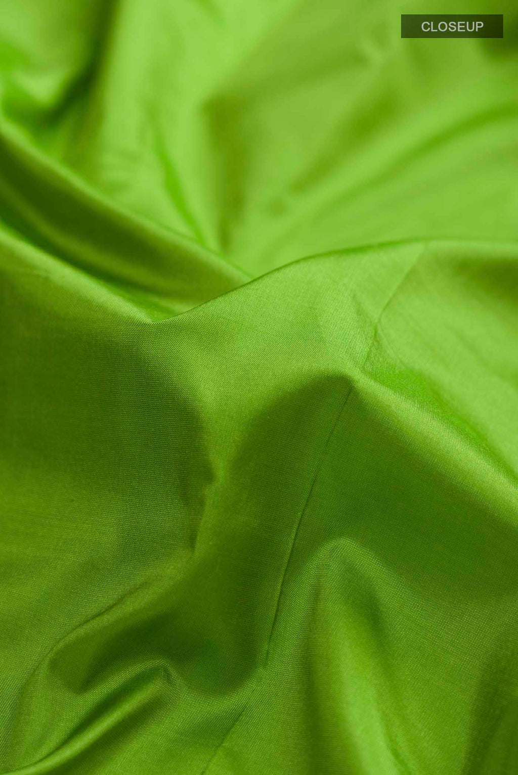 Close up of Green Bangalore Silk Saree with Plain Body and Zari And Thread Border displaying folds