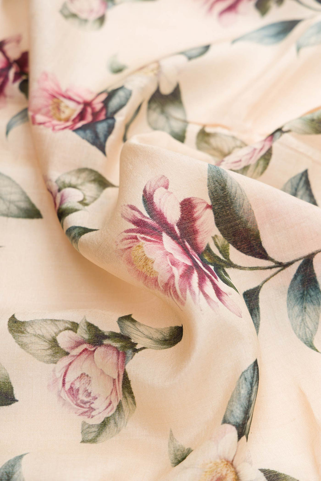 Close up of Sandal Tussar Silk Saree with Floral Print on the body and Zari Border displaying folds