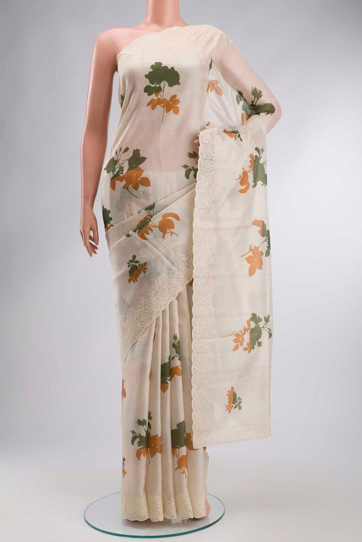 Cream Kota Cotton Saree with Printed design on the body and Thread Border displayed on a mannequin