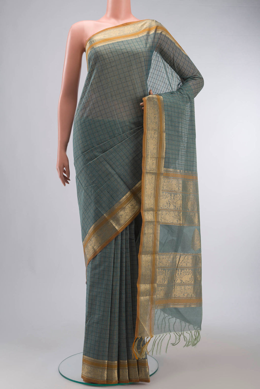 Green Kanchi Cotton Saree with Checked design on the body and Zari Border displayed on a mannequin